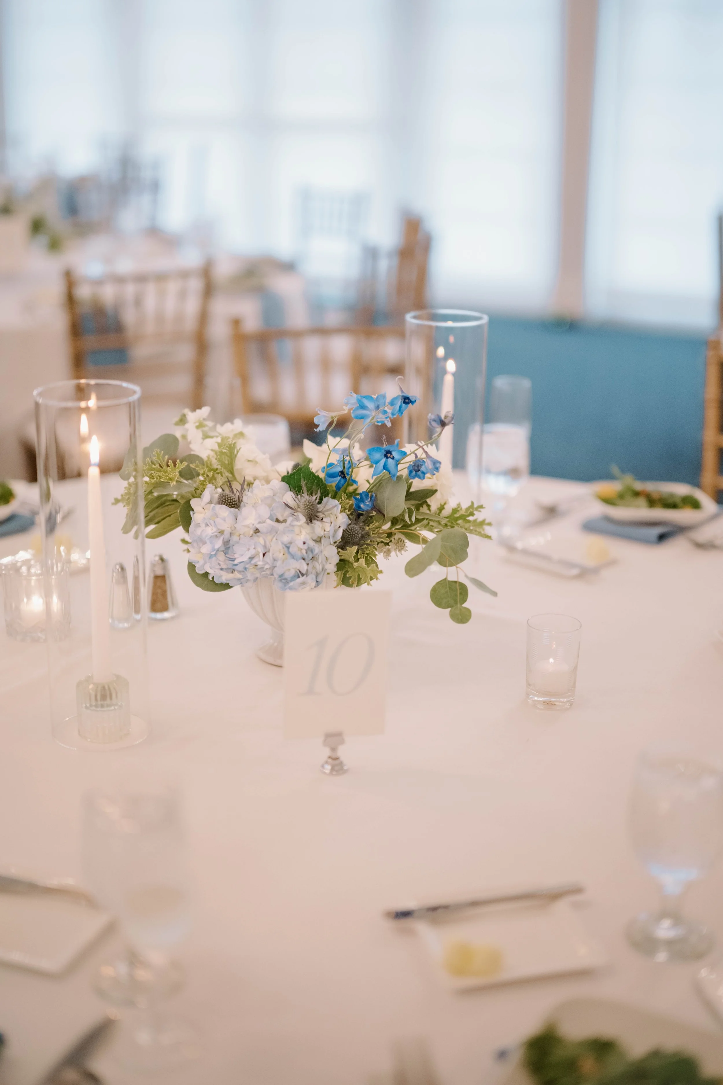 Close-up of blue tweedia and sage foliage wedding flowers designed by First Blush Floral Design CT.