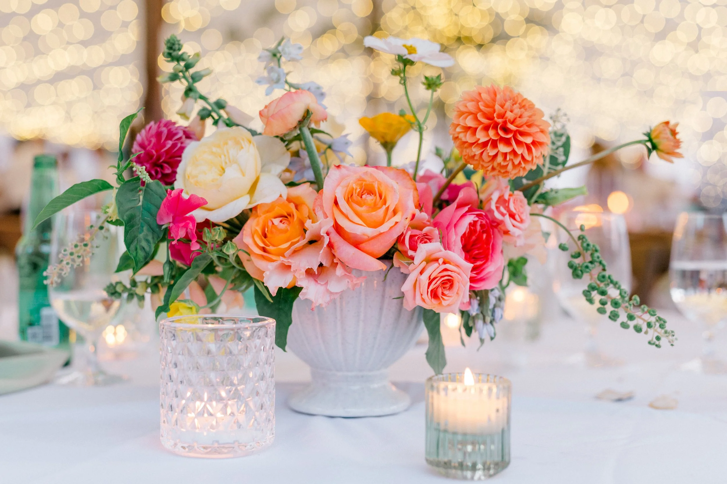 Vibrant Connecticut wedding tablescape featuring roses, zinnias, and delphinium.