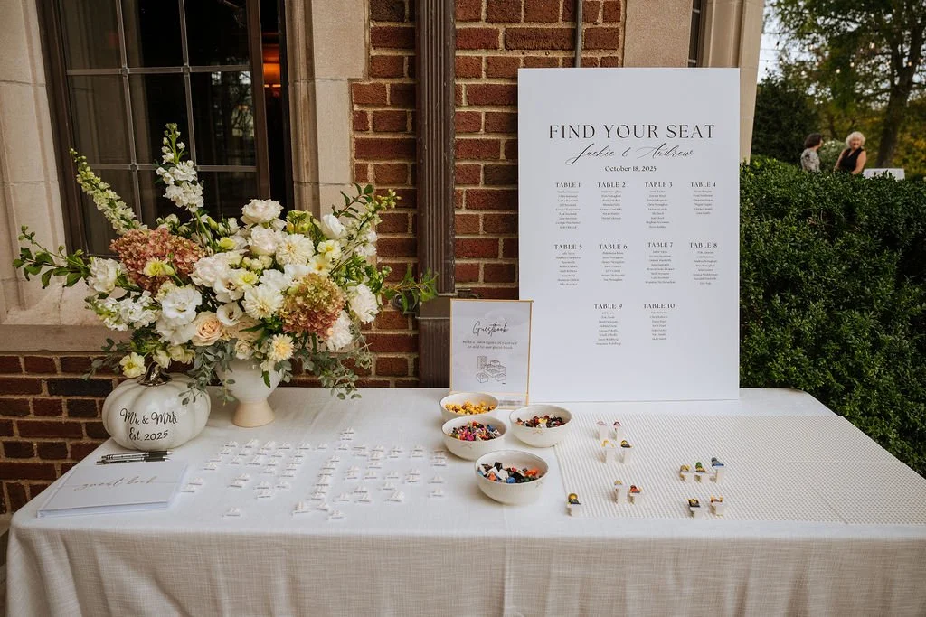 Escort card table with tall garden floral arrangement at Connecticut wedding
