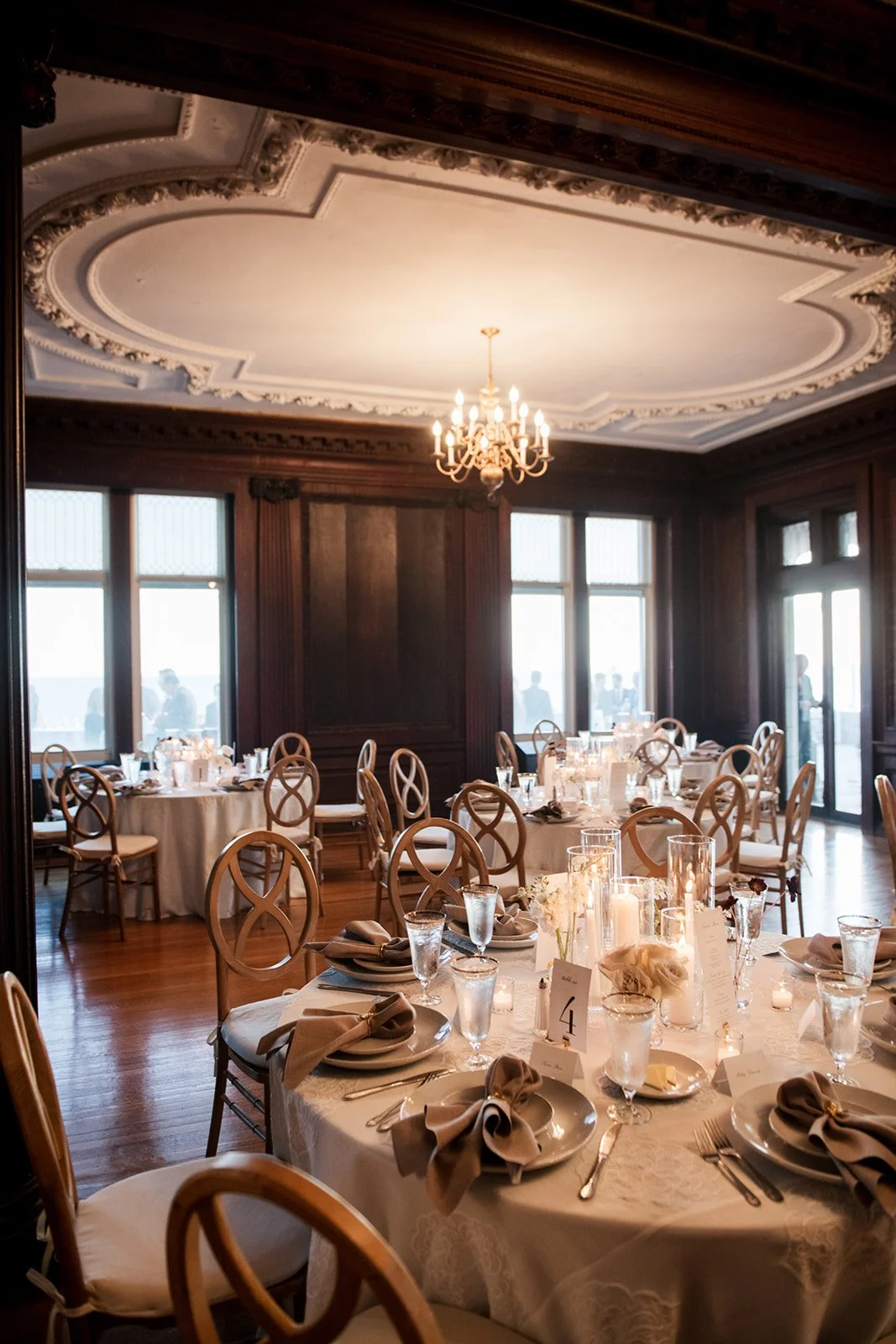 Editorial wedding reception design featuring layered candlelight and sculptural florals.