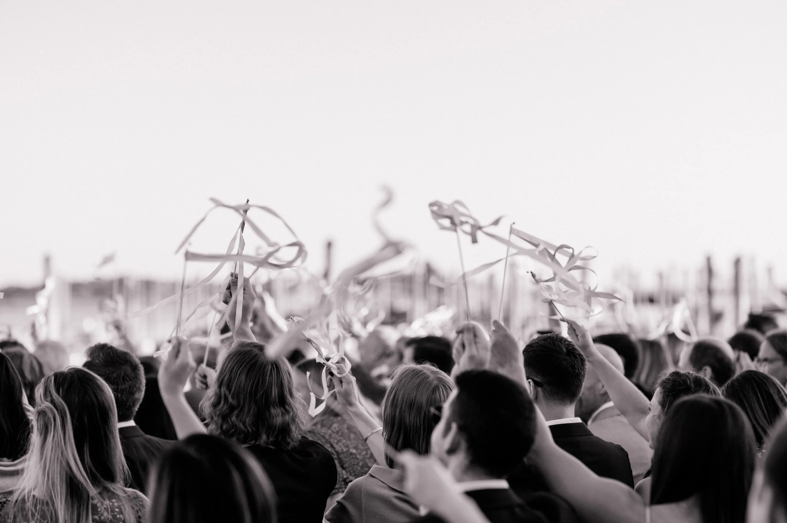 Waterfront ceremony with elevated floral stands overflowing with fall blooms