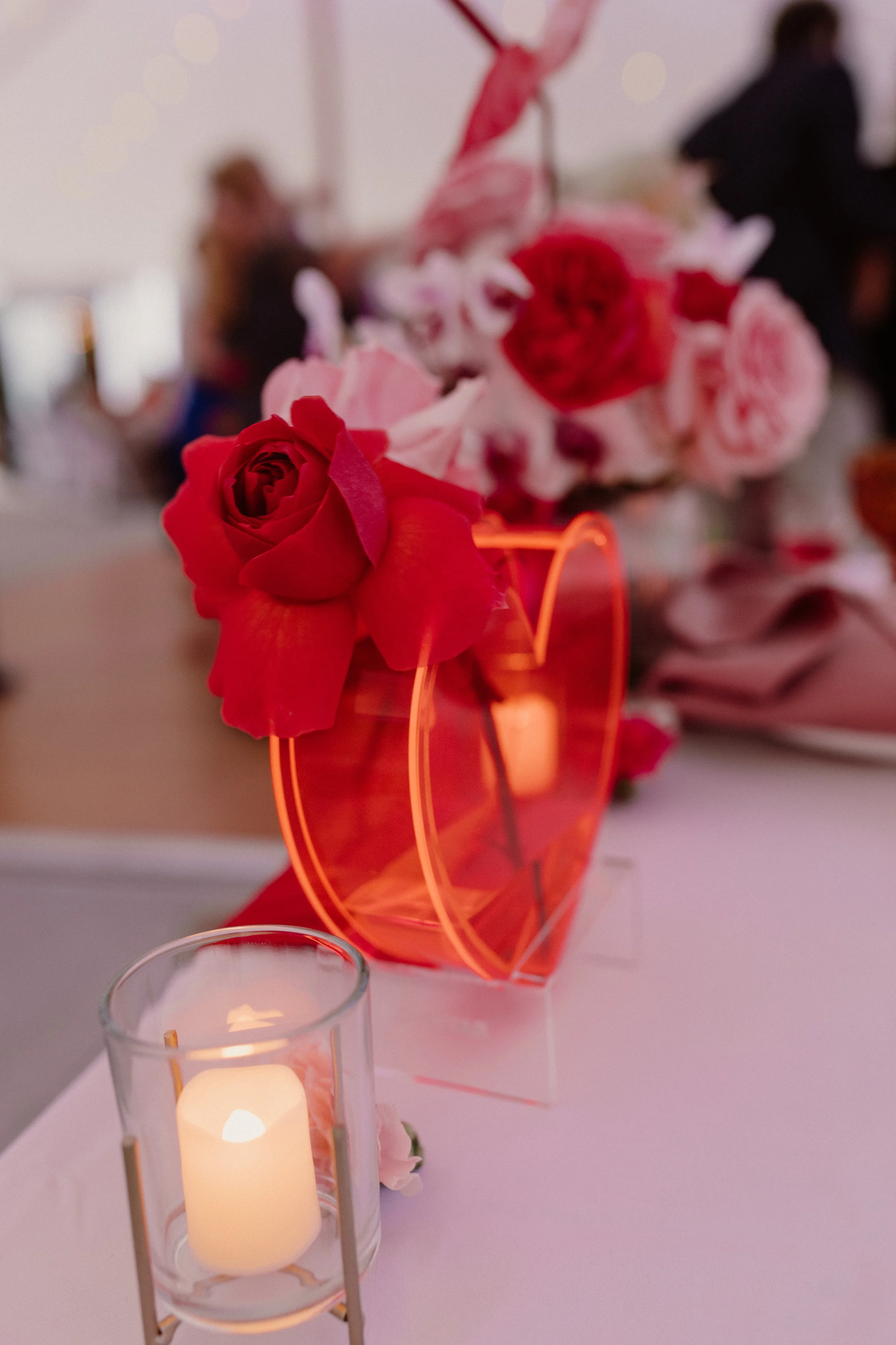 Candlelit wedding reception with bold floral centerpieces and high-energy design.