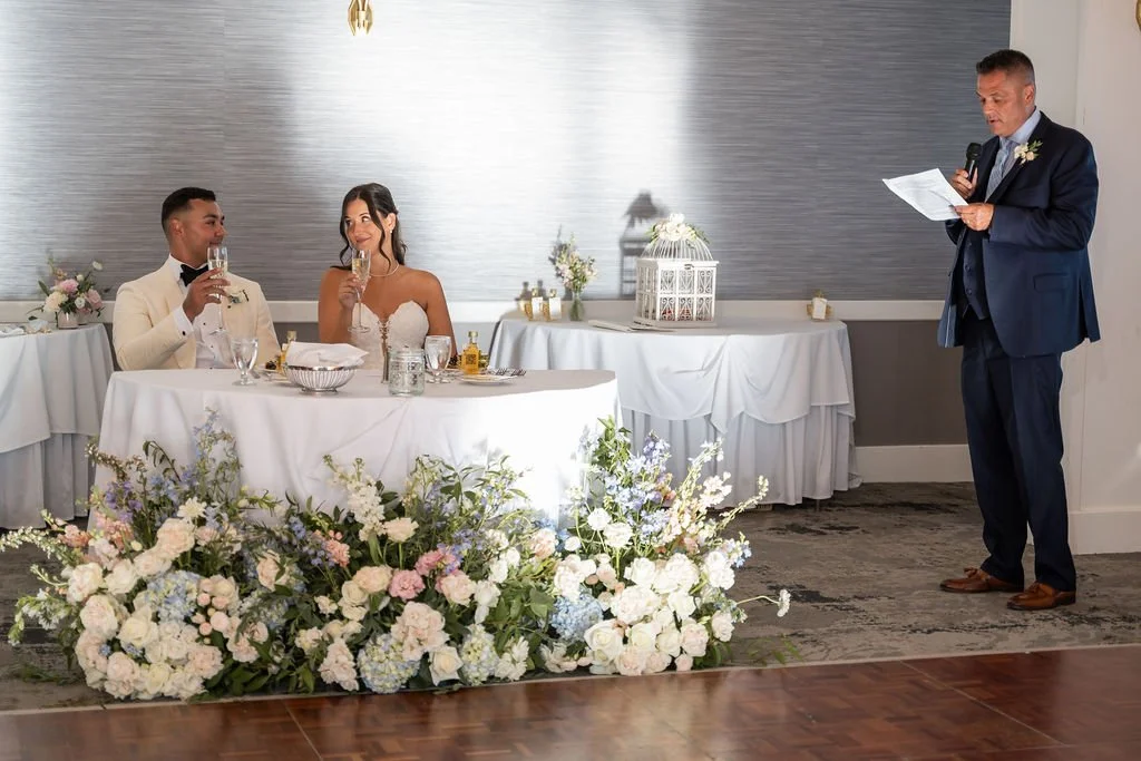 Wedding cake table styled with repurposed garden bouquets in white ivory and blush at Water's Edge Resort Connecticut, First Blush Floral Design