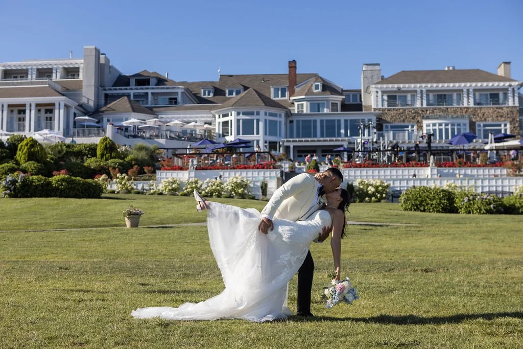 Bride and groom portrait on the waterfront lawn at Water's Edge Resort and Spa Westbrook Connecticut, wedding florals by First Blush Floral Design