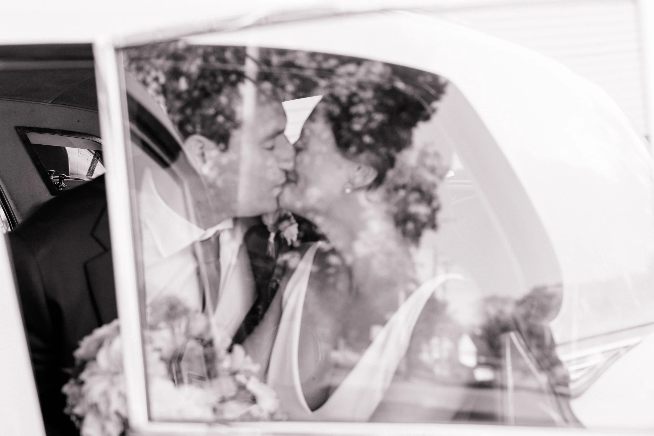 Classic car photo op outside Pine Orchard Yacht & Country Club with bold fall wedding florals.”