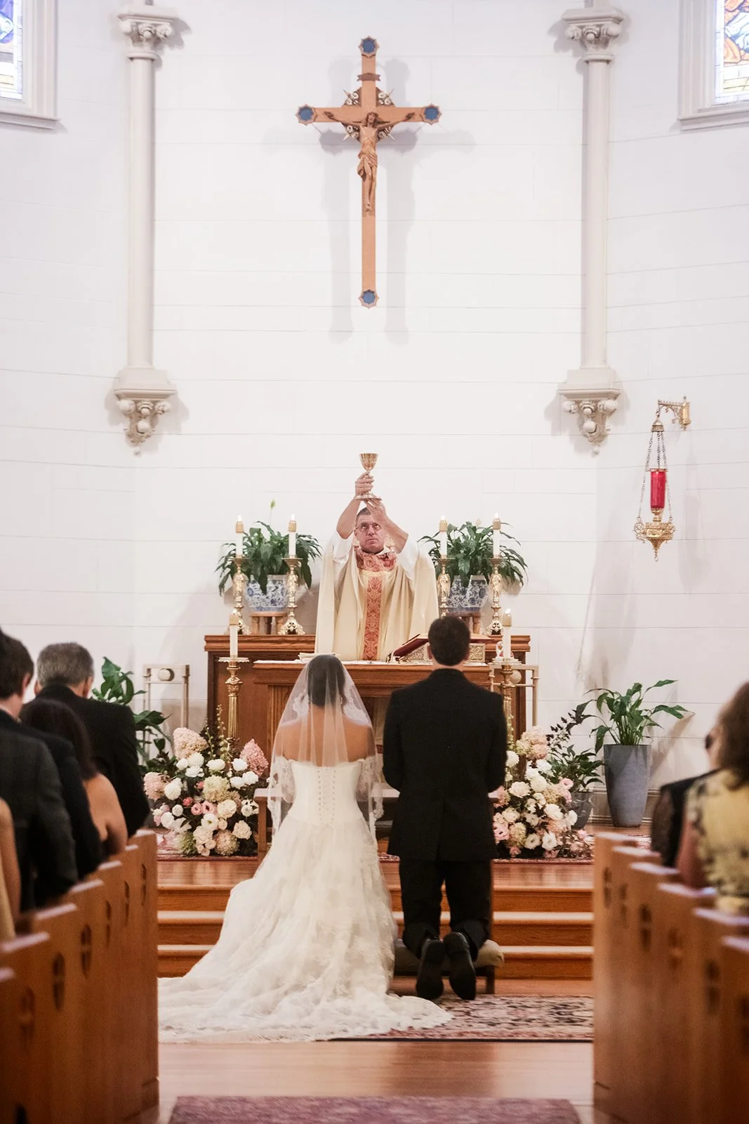 Church wedding ceremony in Connecticut with organic garden-style altar arrangements in white and blush.