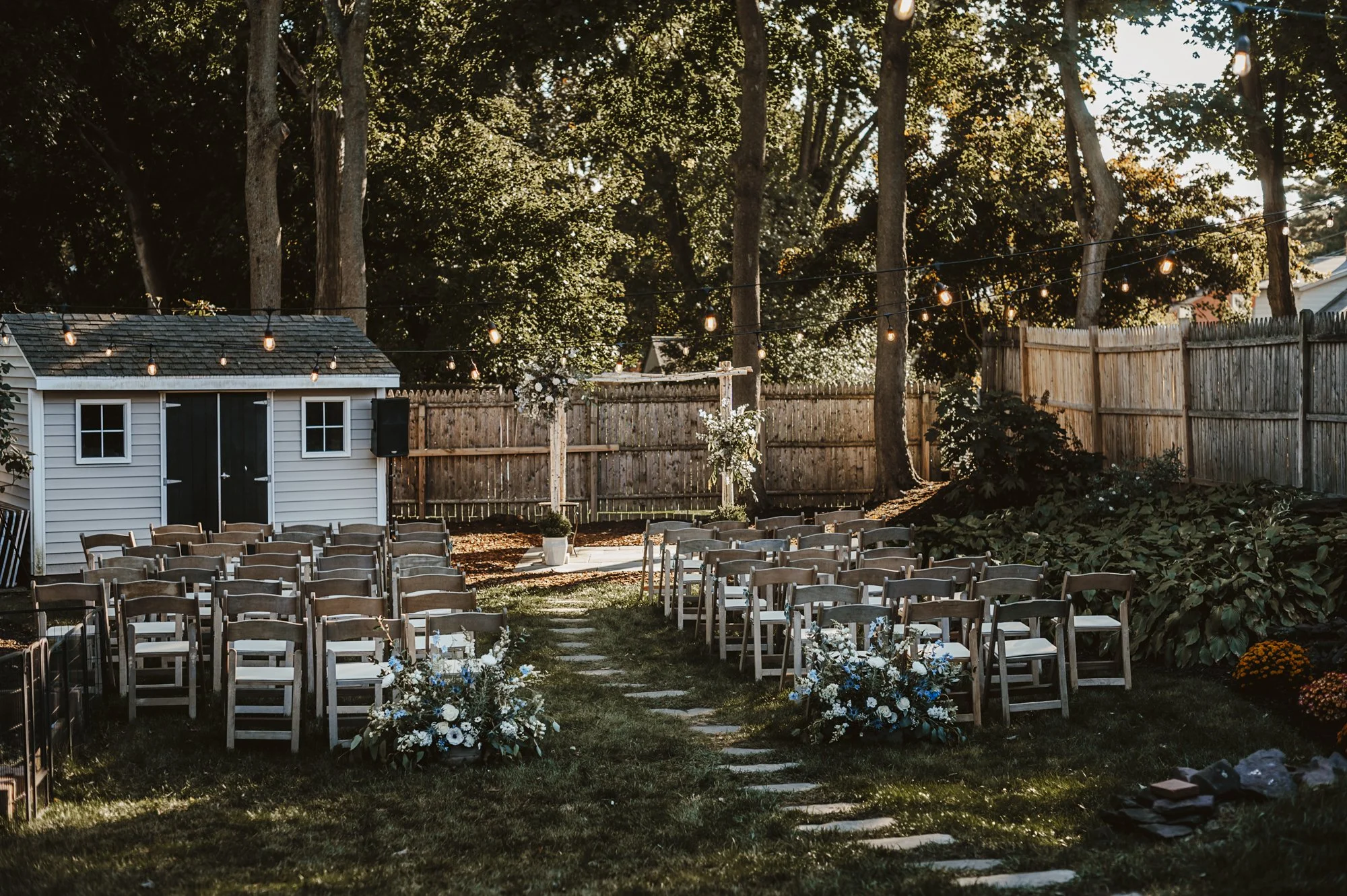 Blue-and-white aisle entrance arrangement for a backyard wedding at a private home in Connecticut