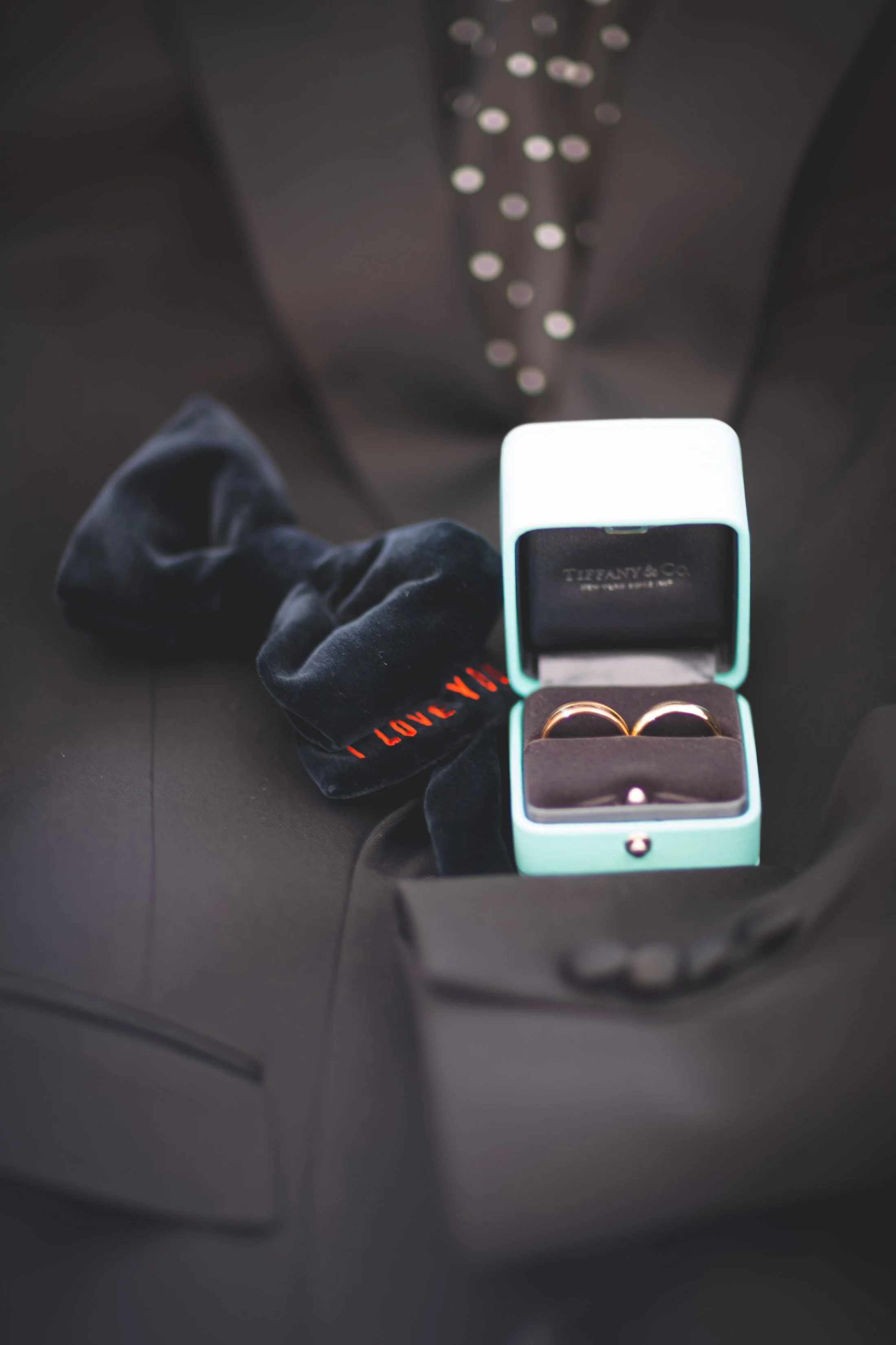 Groom's bow tie and Tiffany & Co. ring boxes arranged for a wedding detail photograph at Saybrook Point in Old Saybrook, Connecticut.