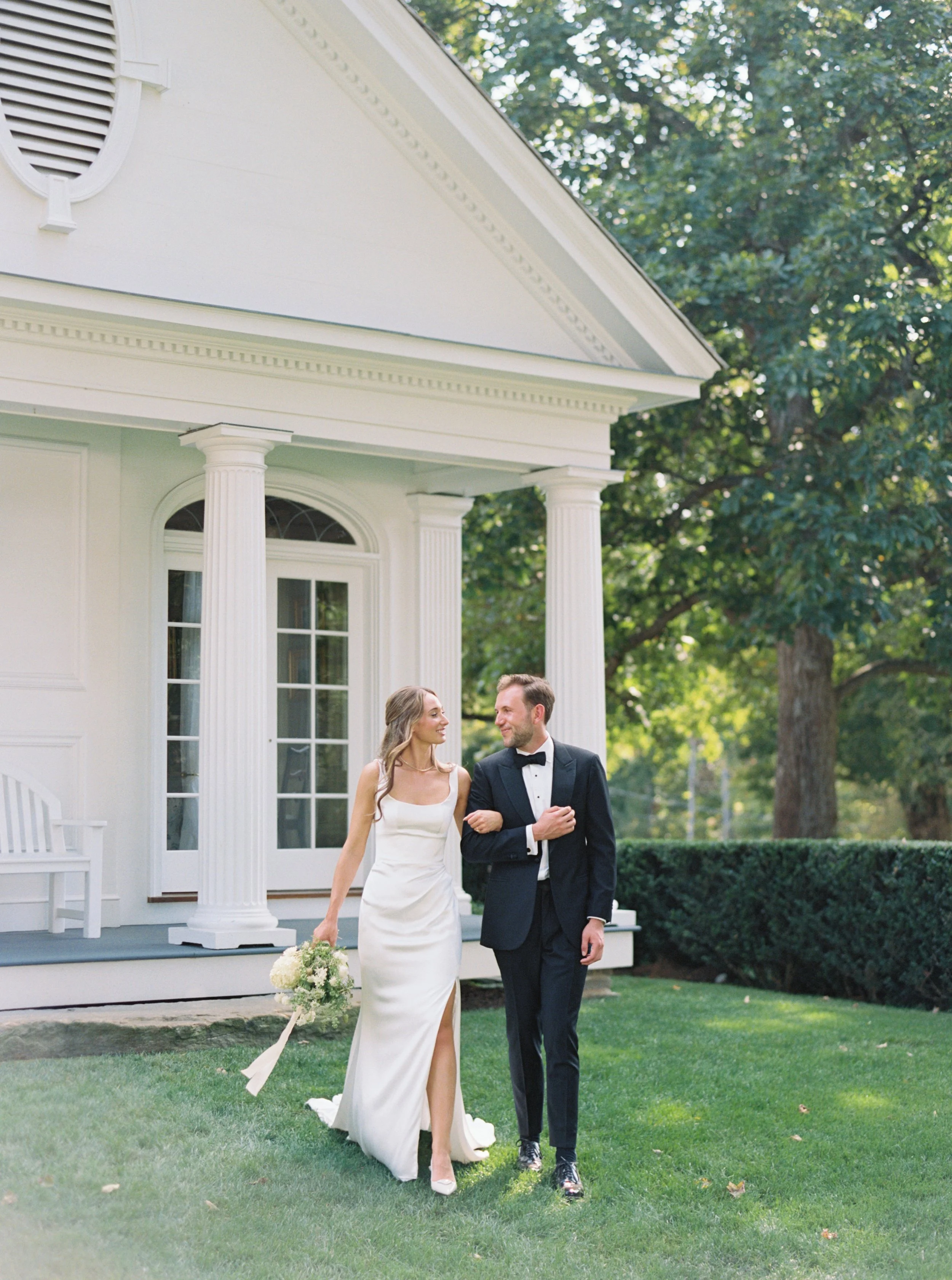 Wedding photography at Smith Farm Gardens featuring couple framed by garden architecture