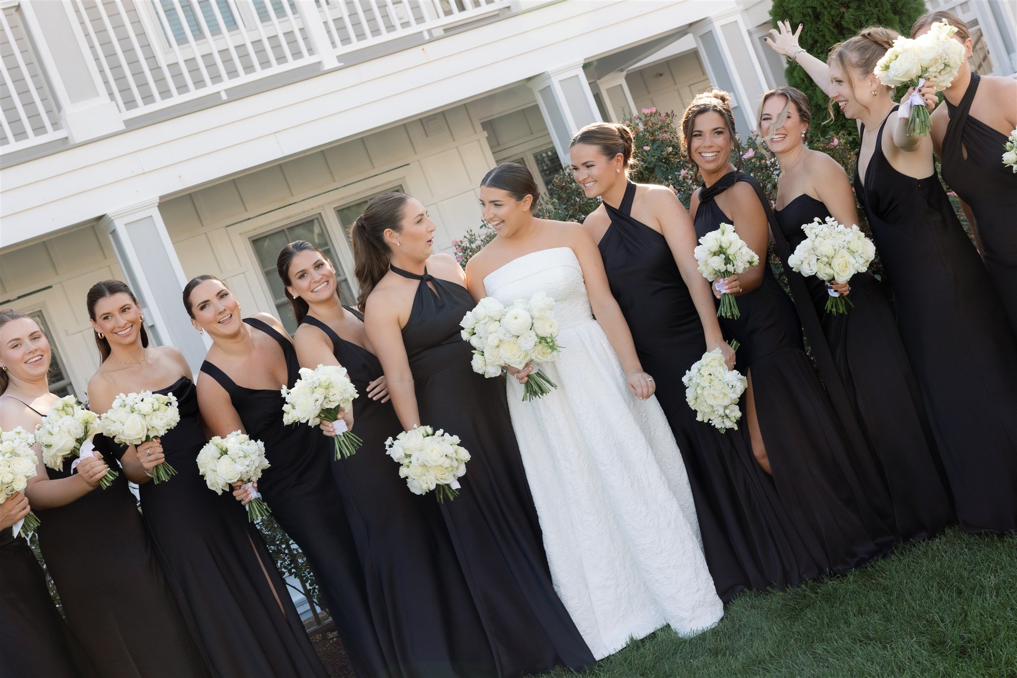 Strapless textured bridal gown photographed outdoors at Water’s Edge with the ocean breeze catching the fabric.