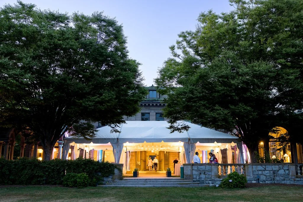 Newlyweds photographed against the historic stone architecture of Eolia Mansion.