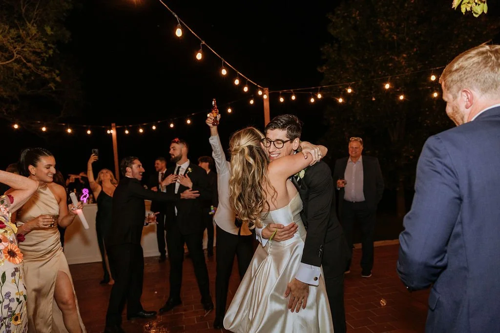 Romantic floral arrangement decorating white bar at fall wedding reception