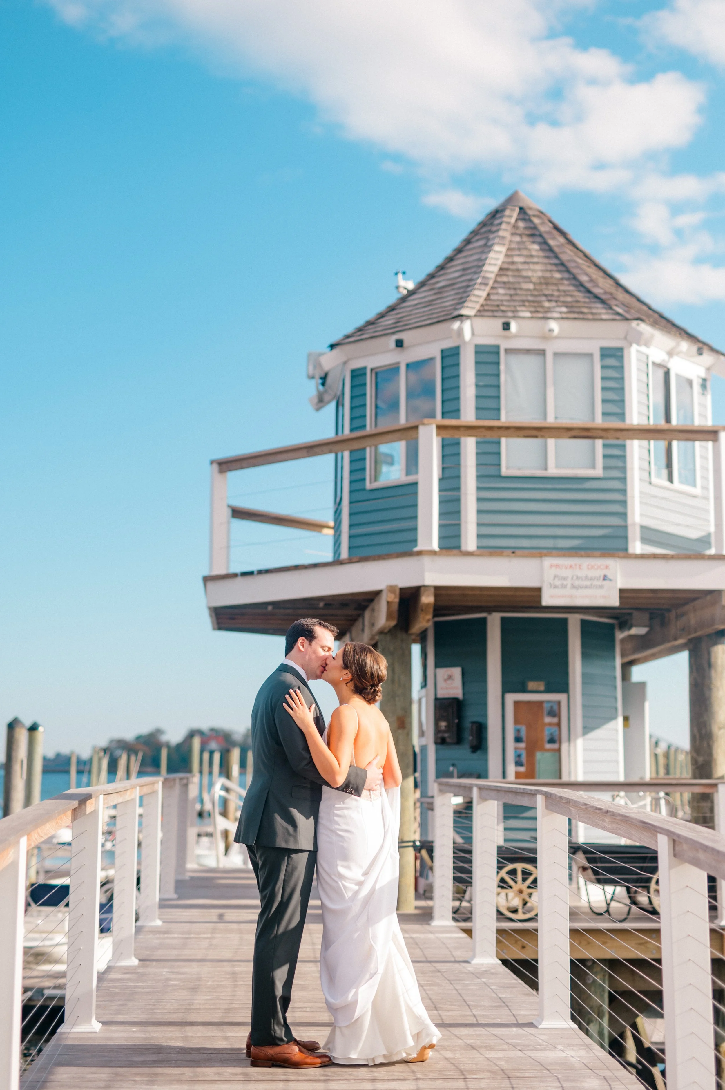 Ceremony lawn at Pine Orchard Yacht & Country Club framed by waterfront views.