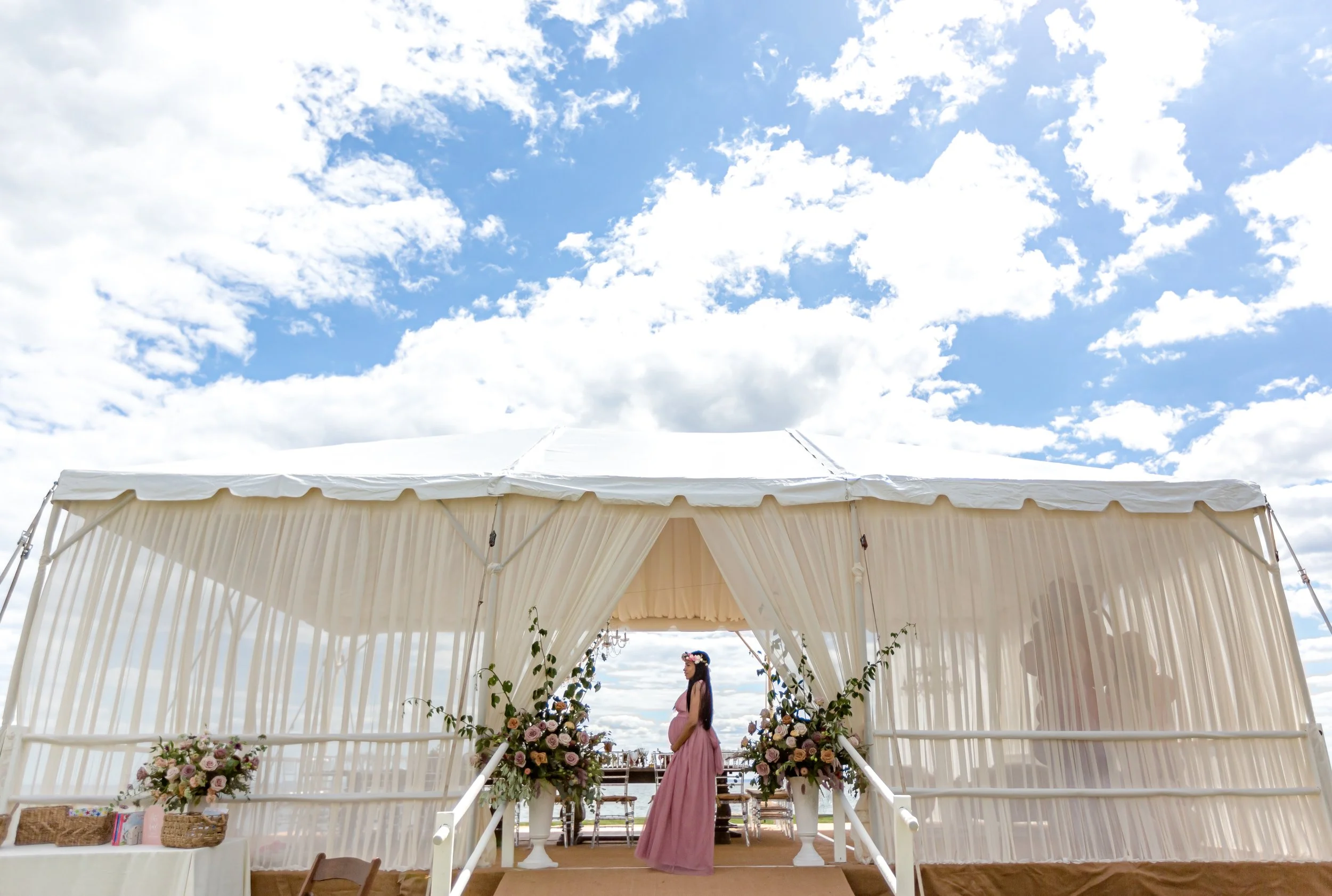 Tall floral arrangement with reaching blooms at a baby shower