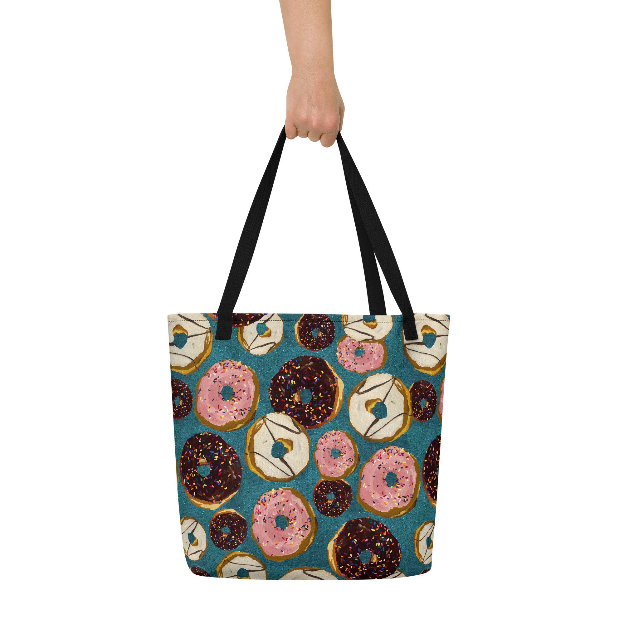 Donuts with rainbow sprinkles in a print designed by Kibby & Co. from original paintings. Chocolate, Strawberry, Vanilla, on teal glitter inspired background. Large tote bag with black handles