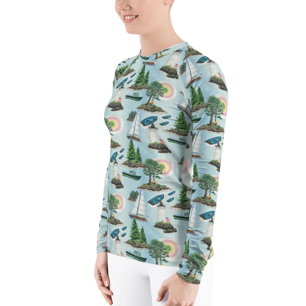 Maine Isles Toile pattern in nautical coastal print. Kibby & Co. in pink, green, yellow, and blue. Long-sleeve crew neck rash guard. Preppy print. Sail boats, islands, light house, sun sailing shirt