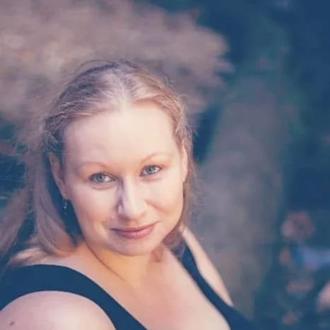 Michelle Noble, freelance editor. A white woman with blond hair wearing a black sundress.