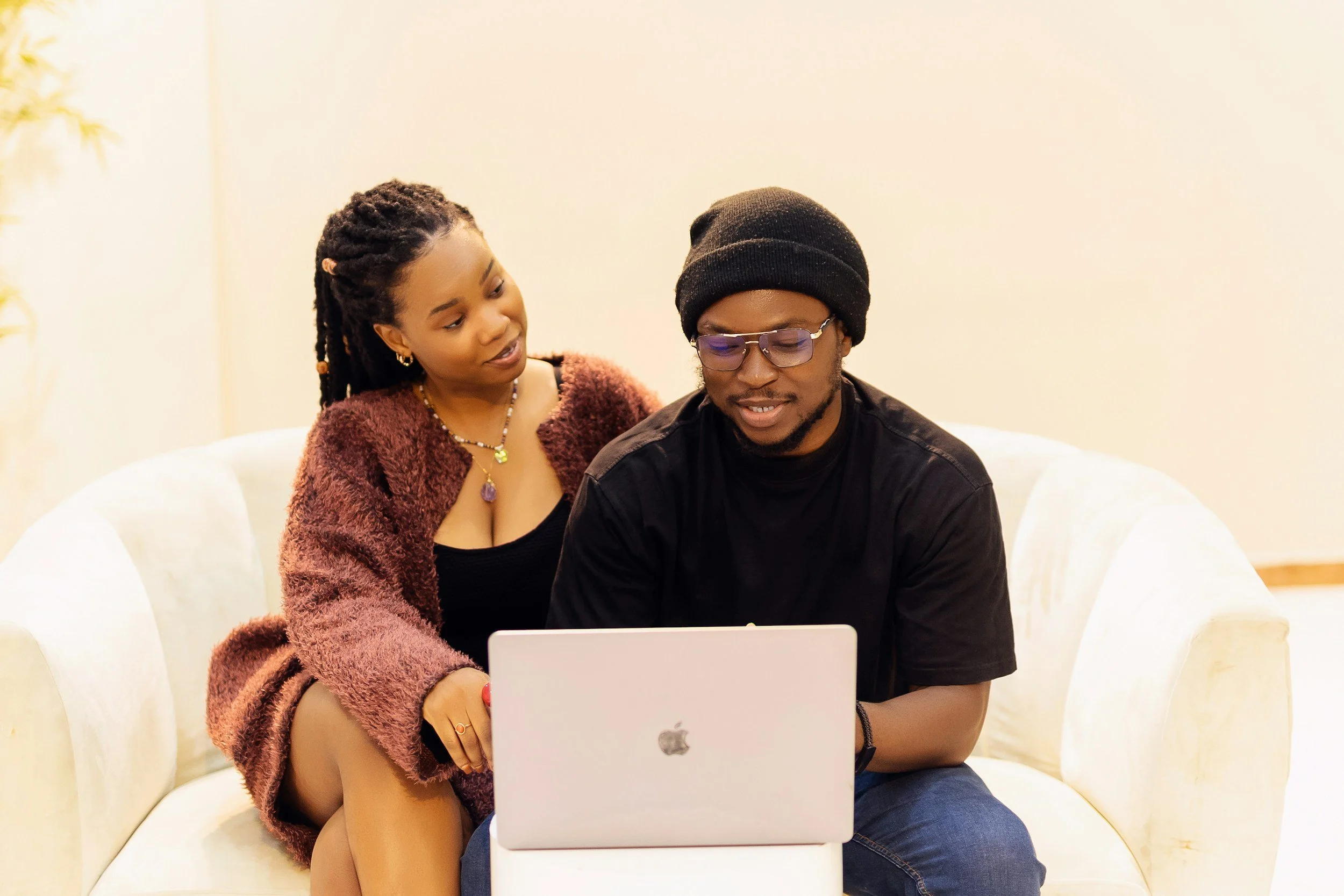 woman and man looking at computer smiling