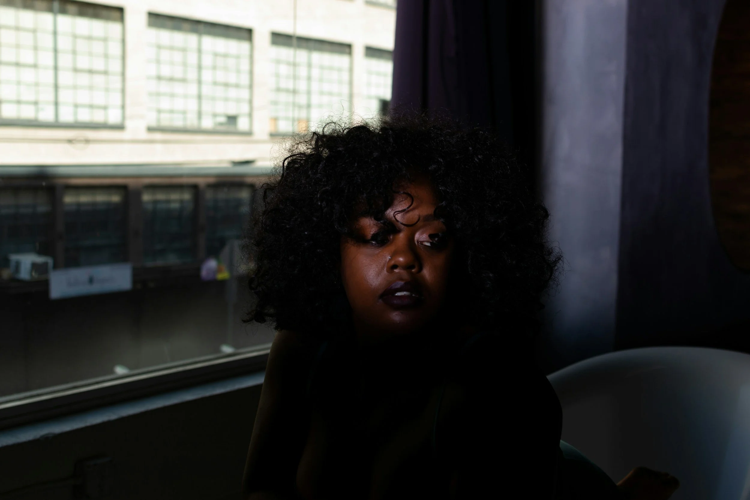 black woman sitting looking away
