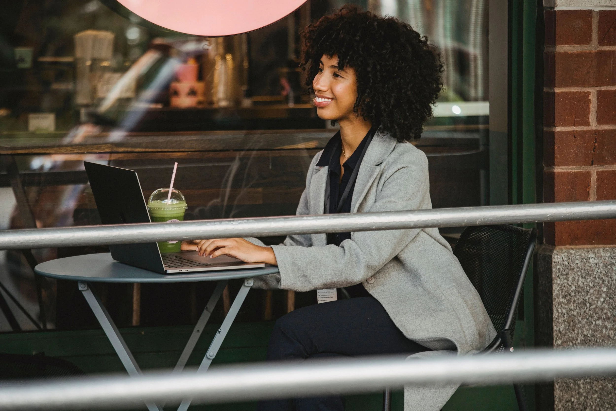 black woman sitting at cafe with
