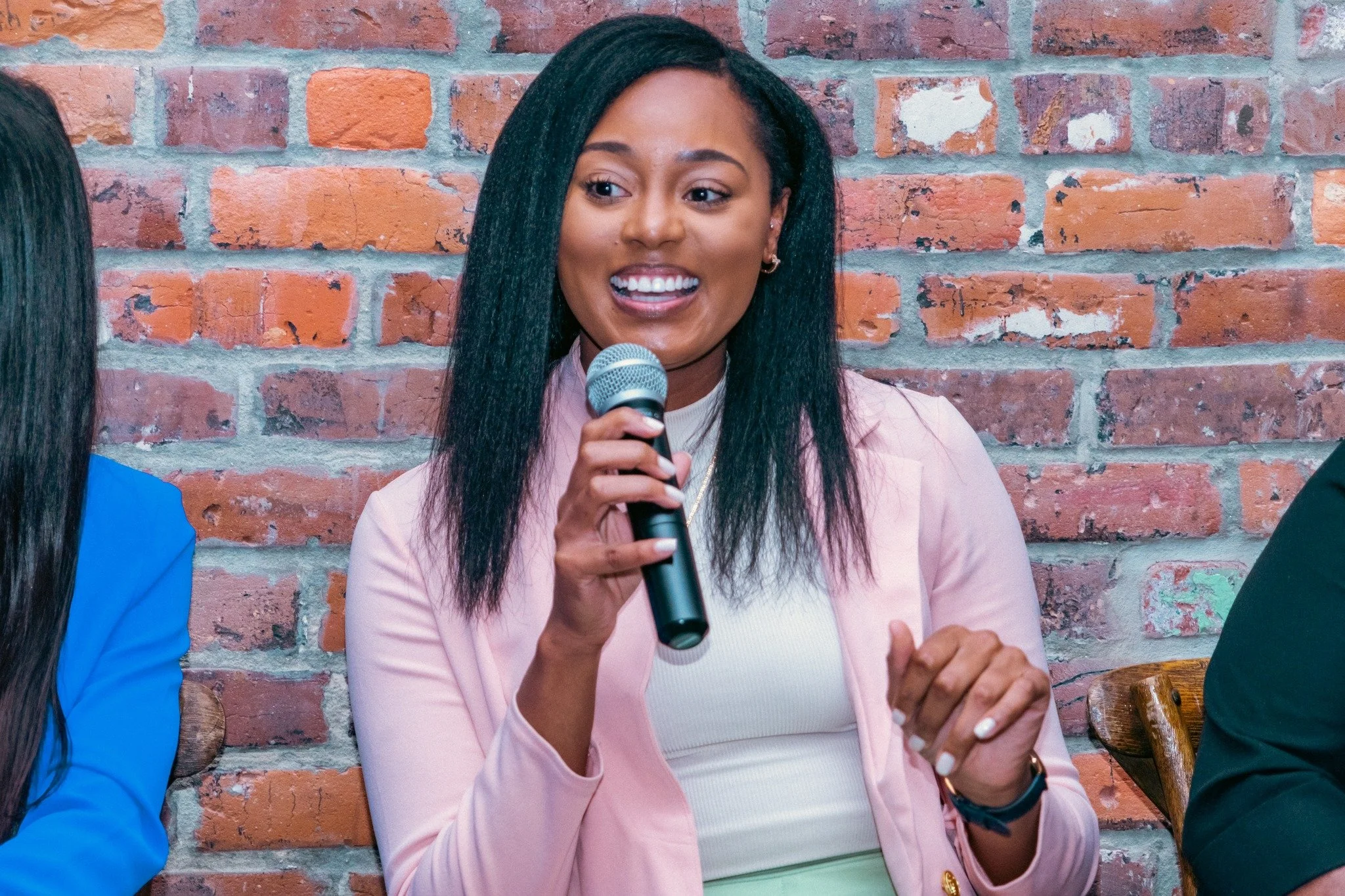 woman holding microphone speaking