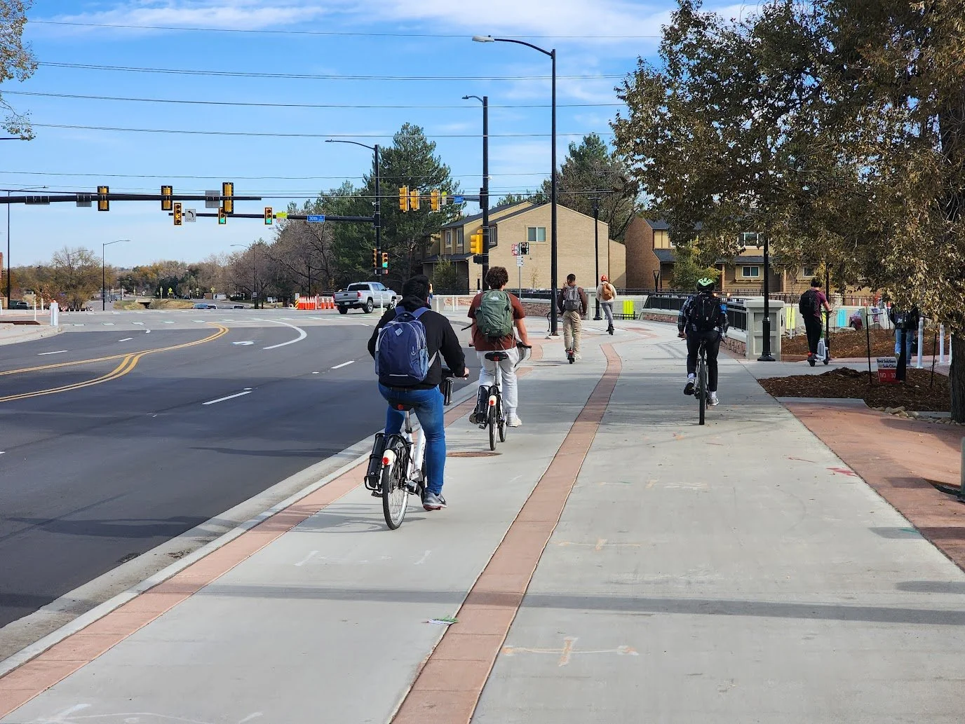 People biking and walking on the protected bike lane and multi-use path at 30th and Colorado