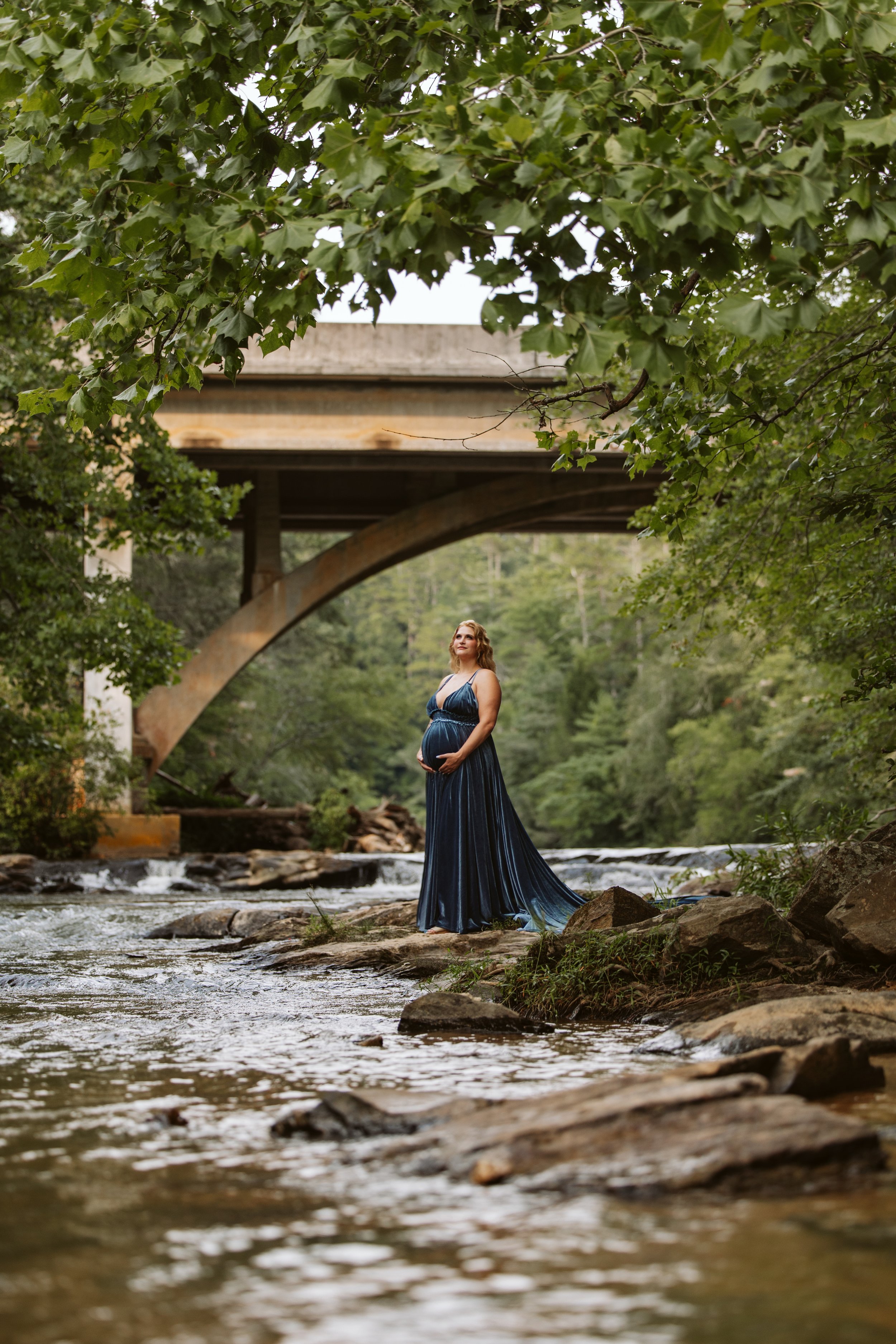 Dramatic outdoor maternity photography in the North Georgia mountains near Dahlonega, serving maternity clients from Alpharetta, Milton and Cumming GA. River photos