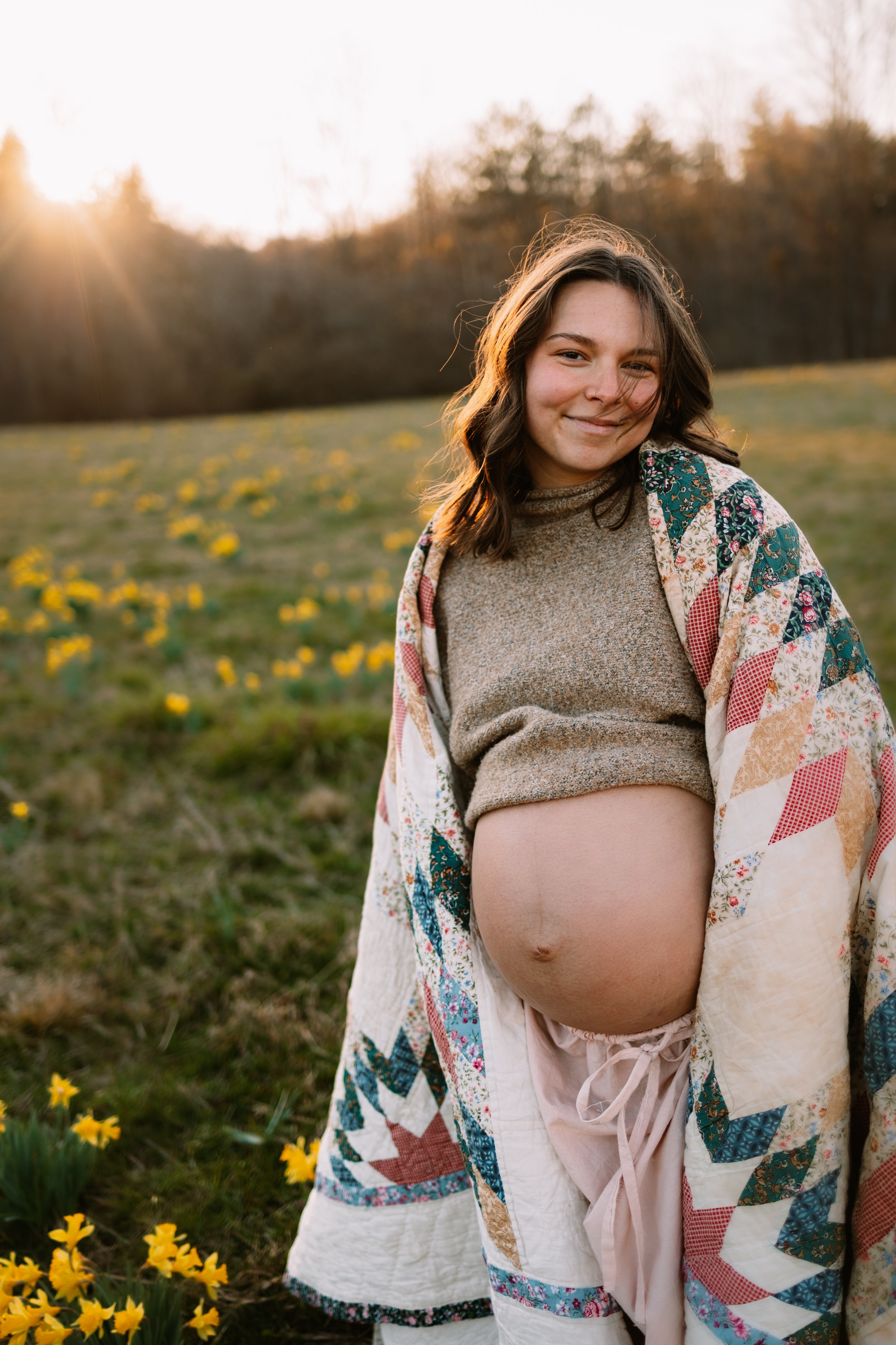 Golden hour maternity photography in Dahlonega GA with spring flowers, serving expecting mothers from Cumming, Milton, Alpharetta and North Georgia.