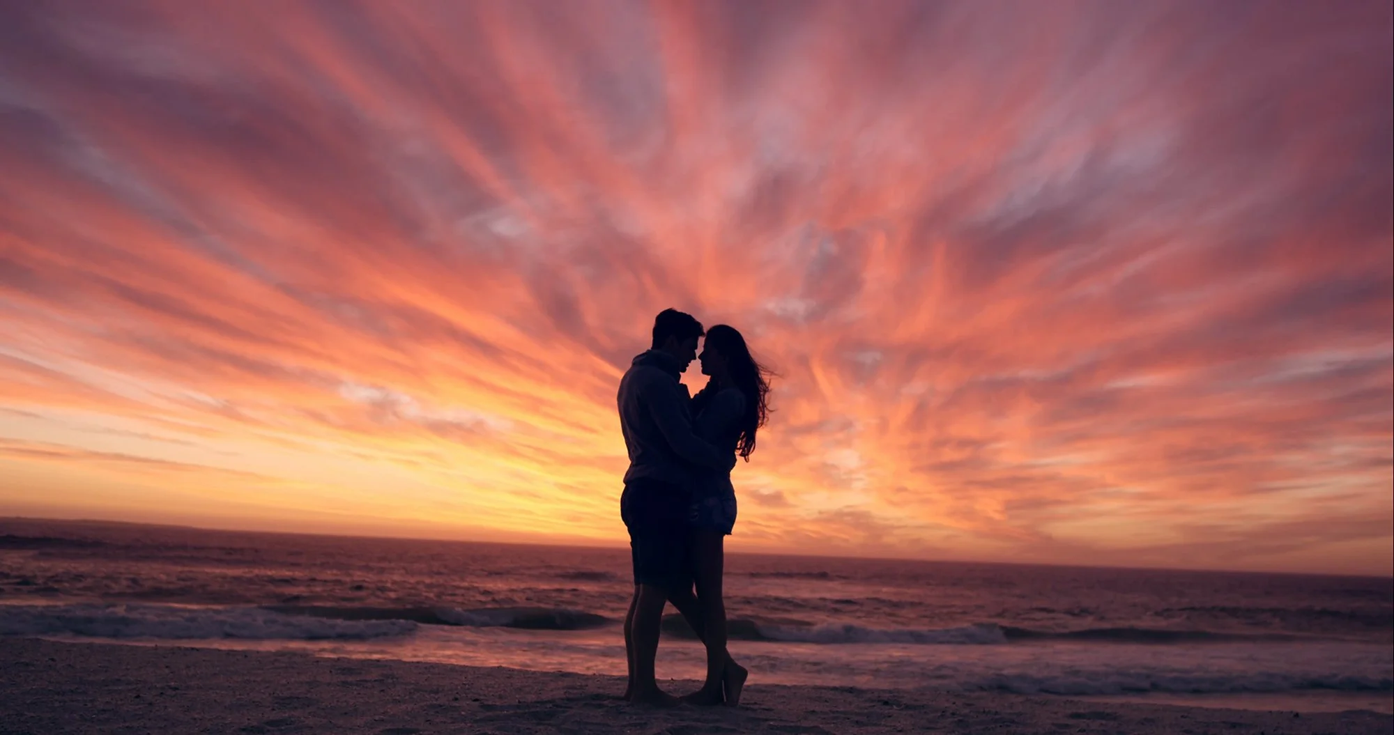 happy-couple-kissing-on-beach-at-sunset-silhouette-in-love-dating-on-honeymoon-red-dragon_4yed68tgu__F0000.jpg