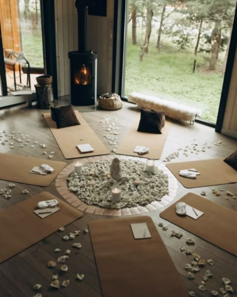 small group meditation and lunar workshop setup with yoga mats, candles and ritual elements.