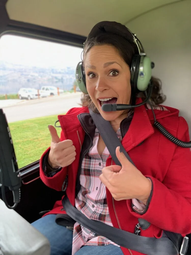 Woman in Helicopter Gives a Thumbs Up