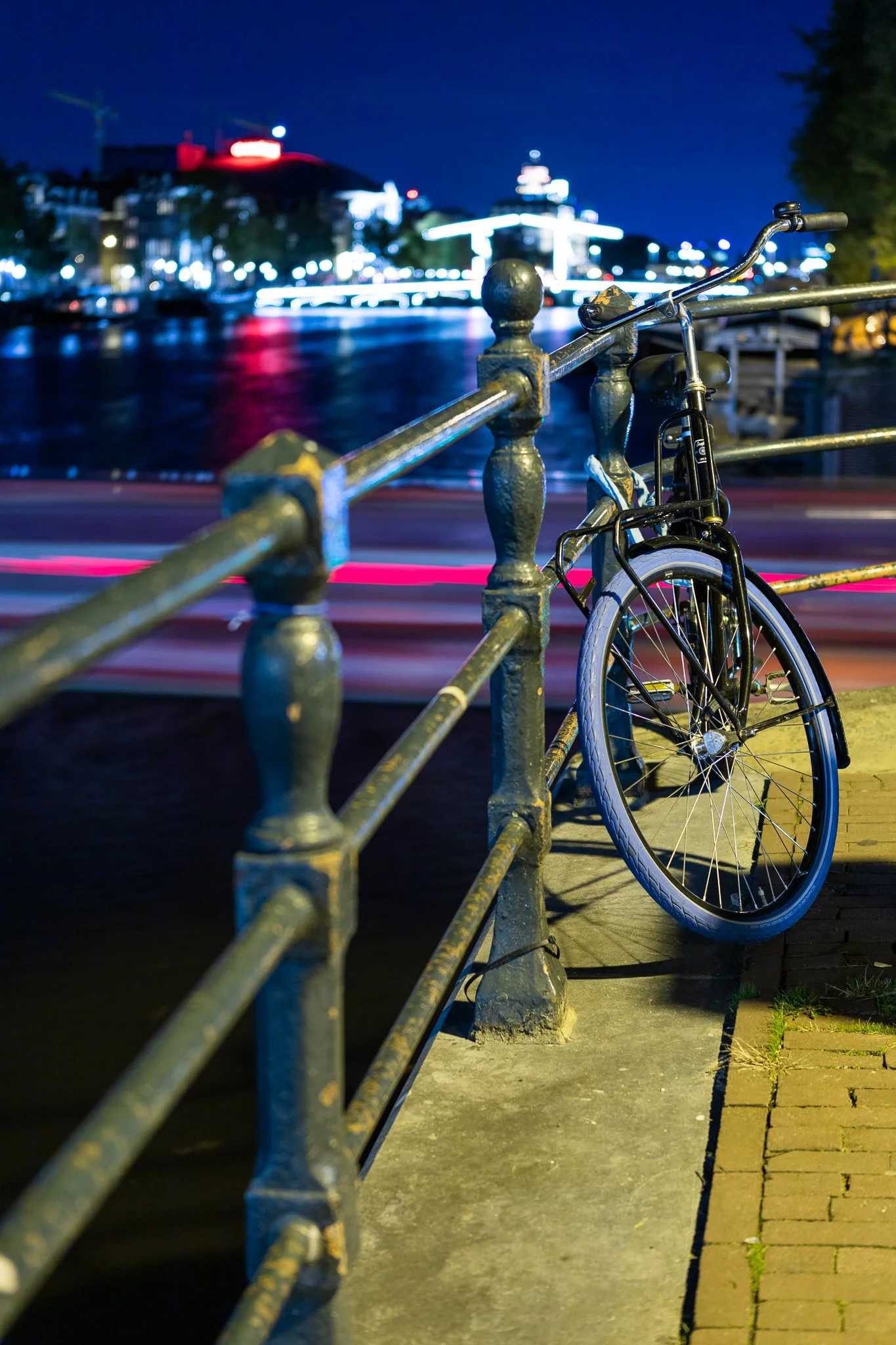 Bicycle on the Amstel riverbank at night