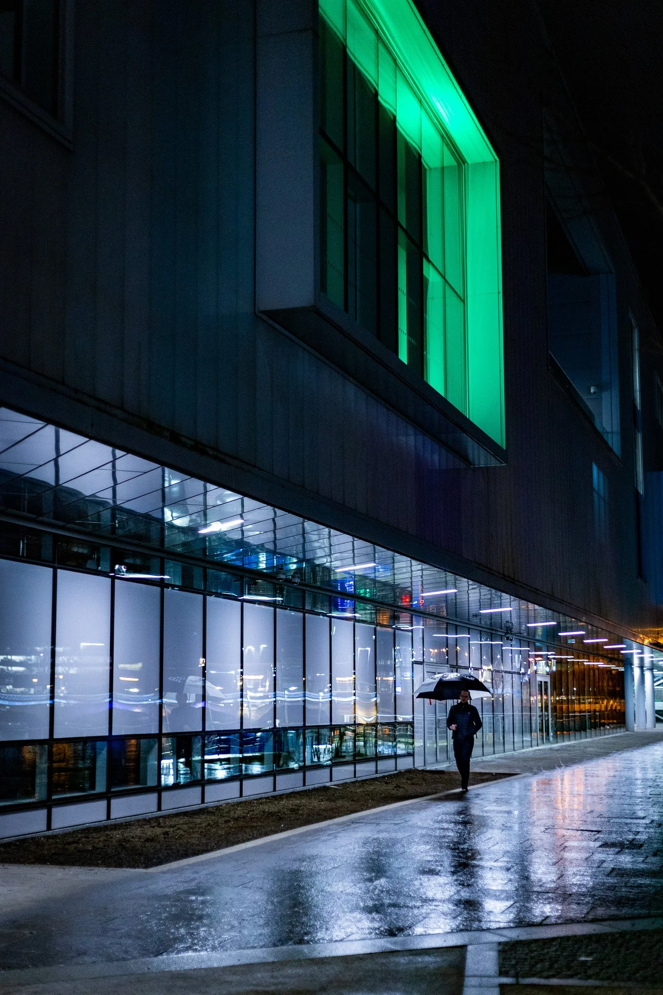 Man with umbrella at Waterfront Hall, Belfast