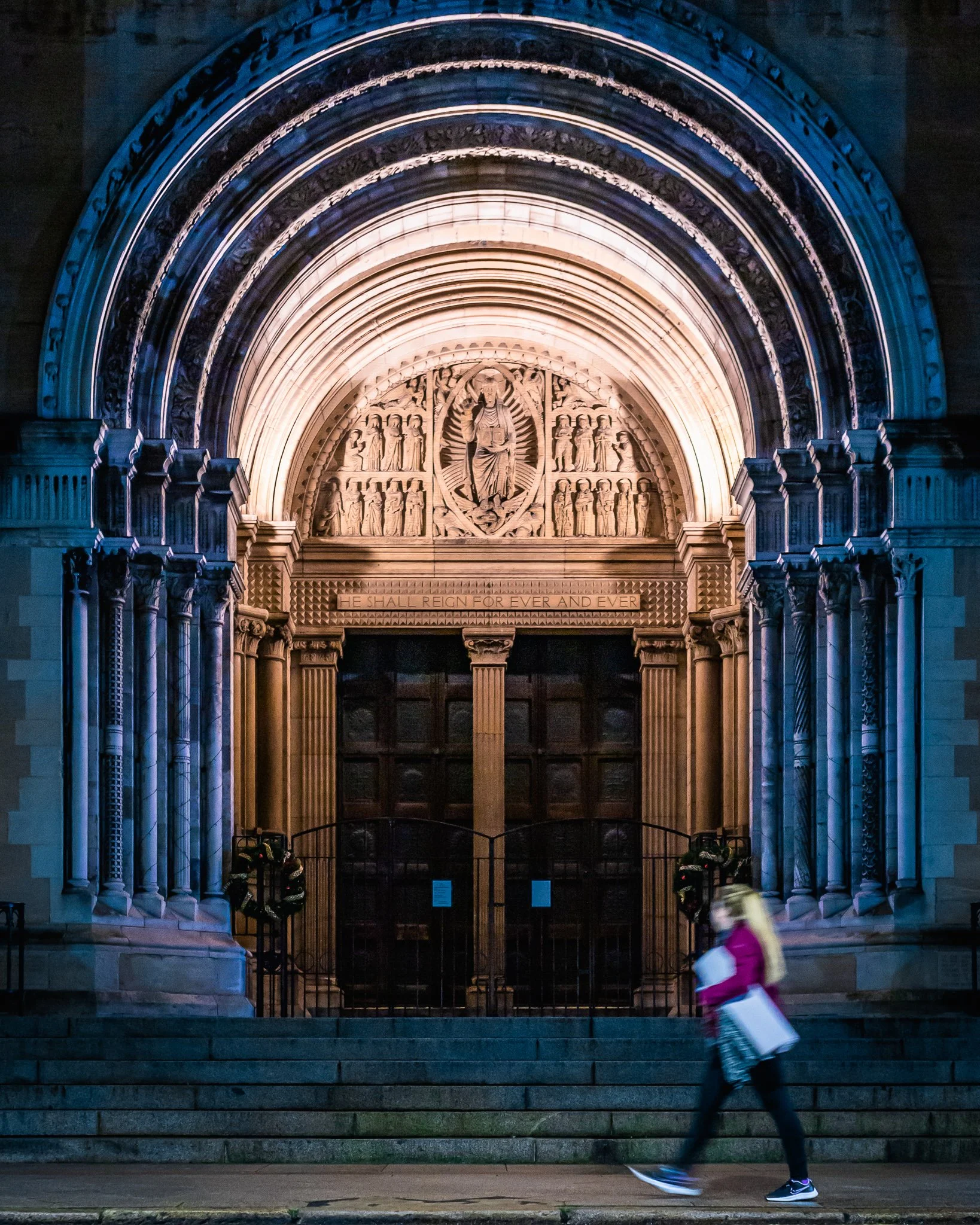 Young lady with yoga mat passing St Anne's cathedral, Belfast