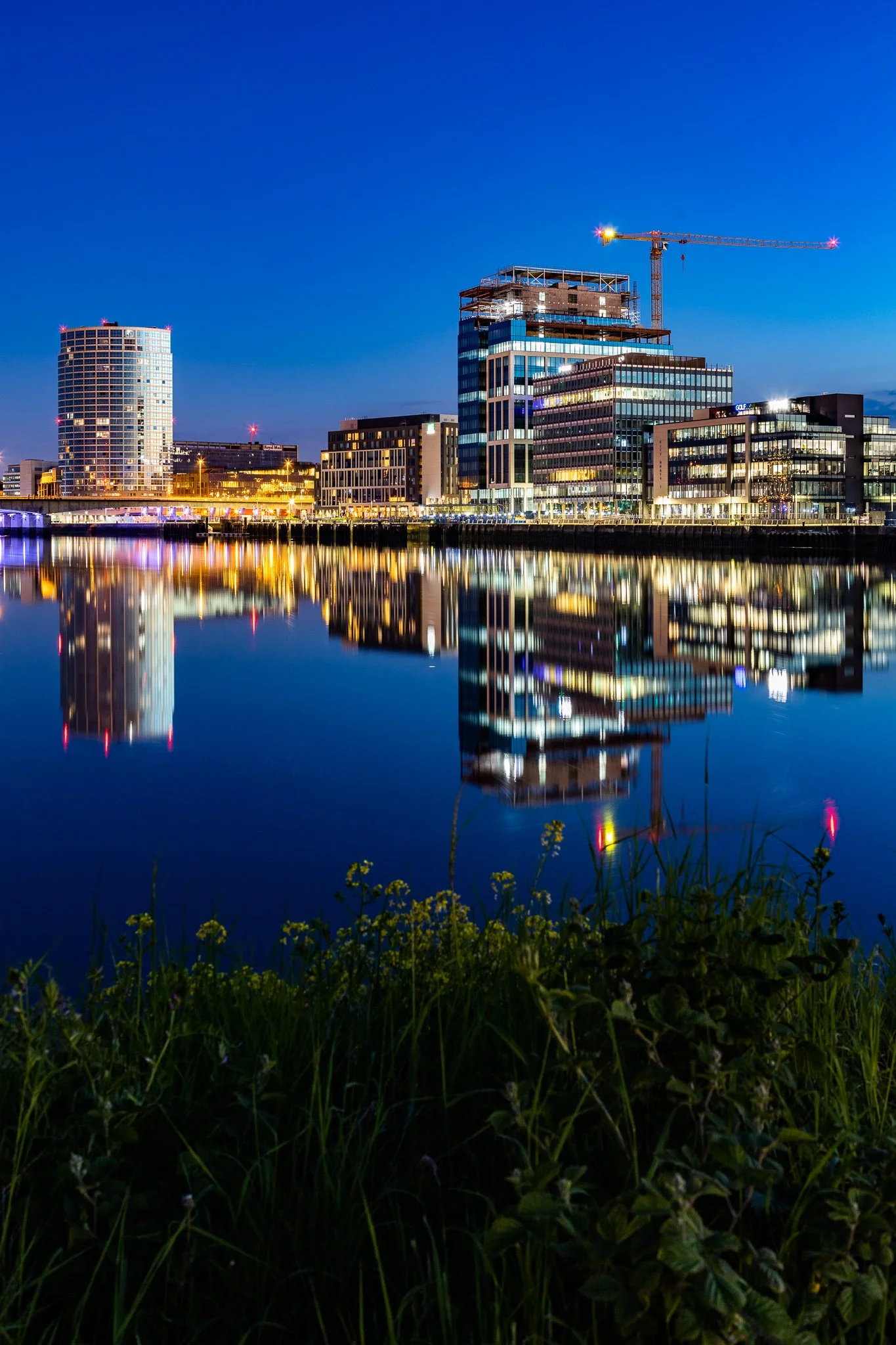 Obel tower and City Quays, Belfast reflections at twilight in river Lagan
