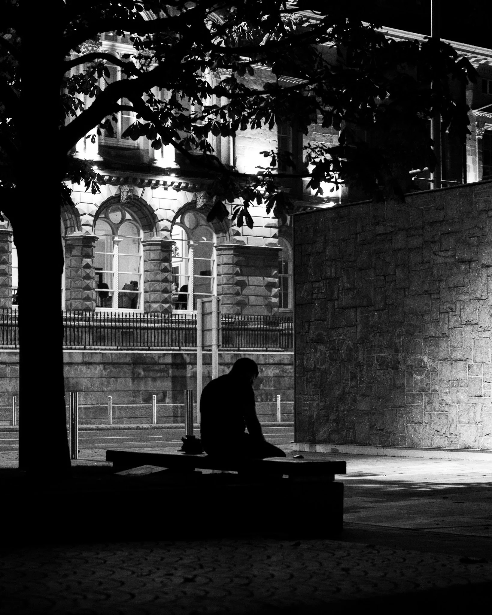 Man sitting alone at Belfast customs house, Belfast