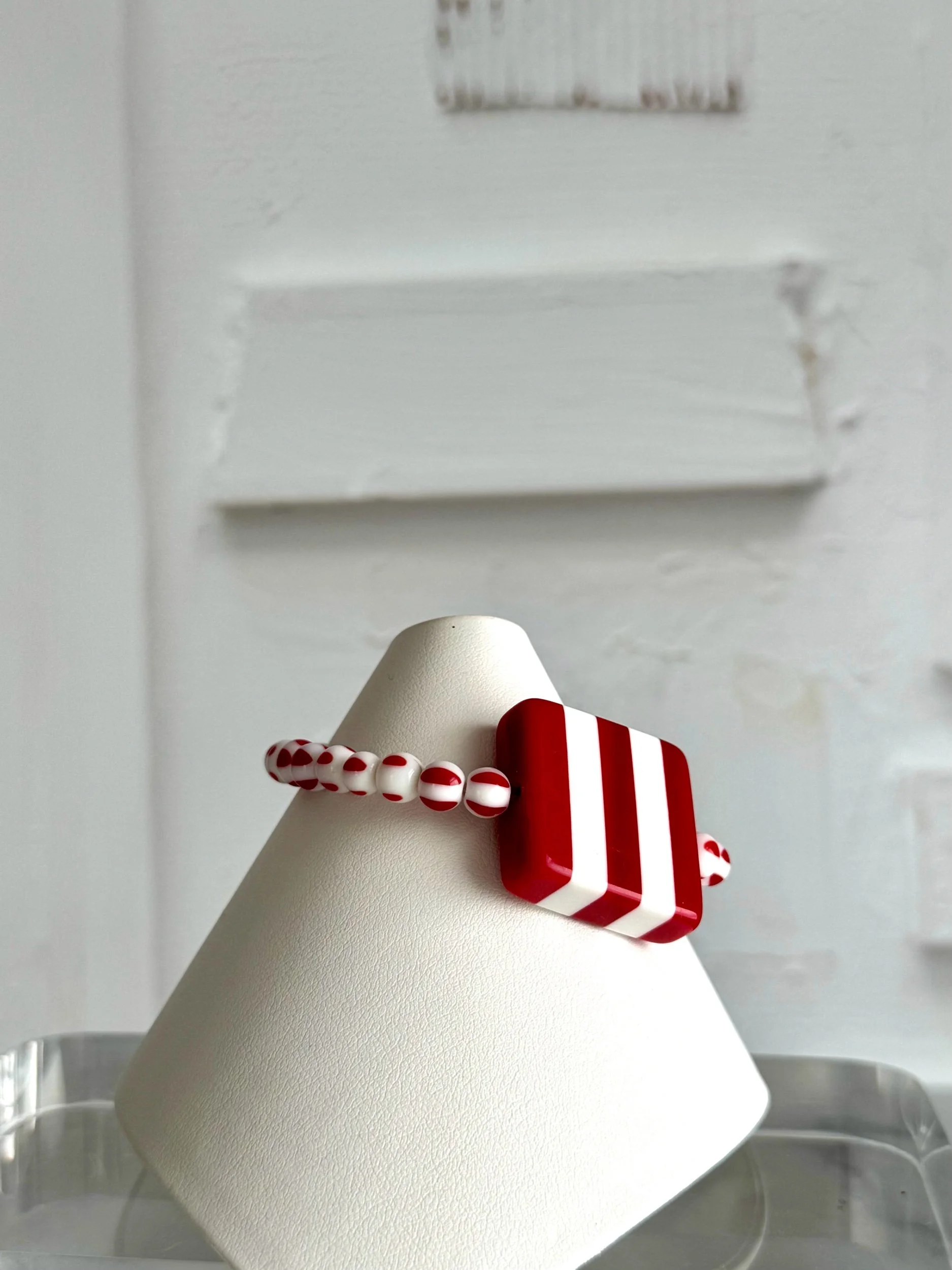 red and white stripe square lucite bead bracelet with red and white glass bead.