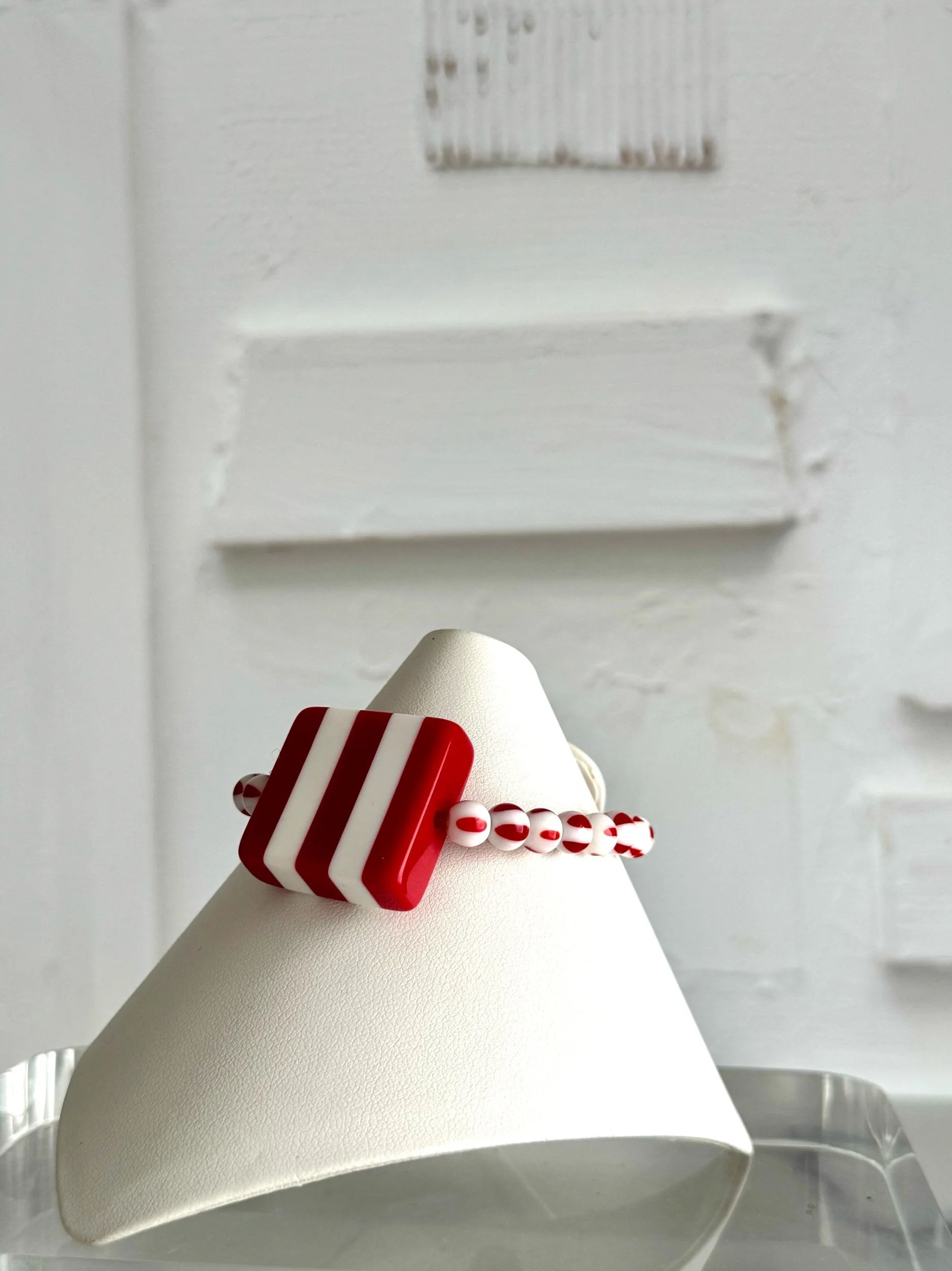 red and white stripe square lucite bead bracelet with red and white glass bead.