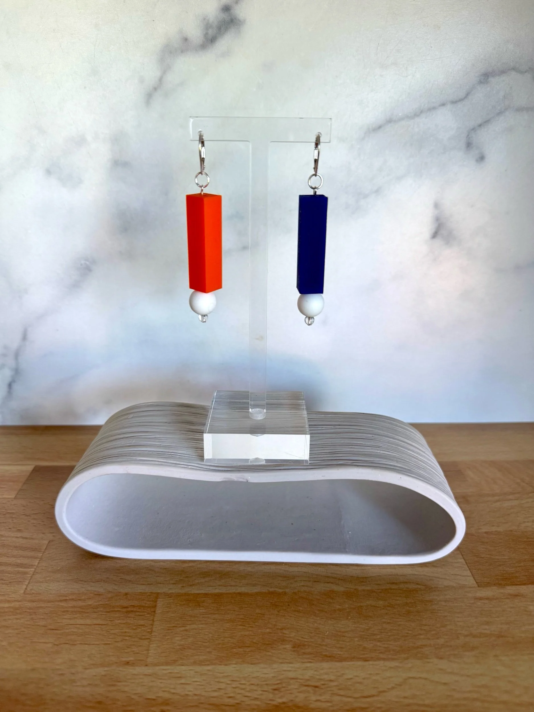rubber orange and blue earrings with white accent