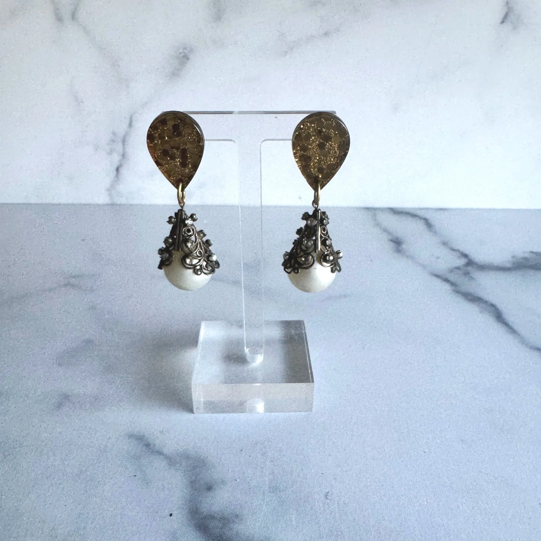faux vintage pearl with fancy caps and piercing with tear drop post.