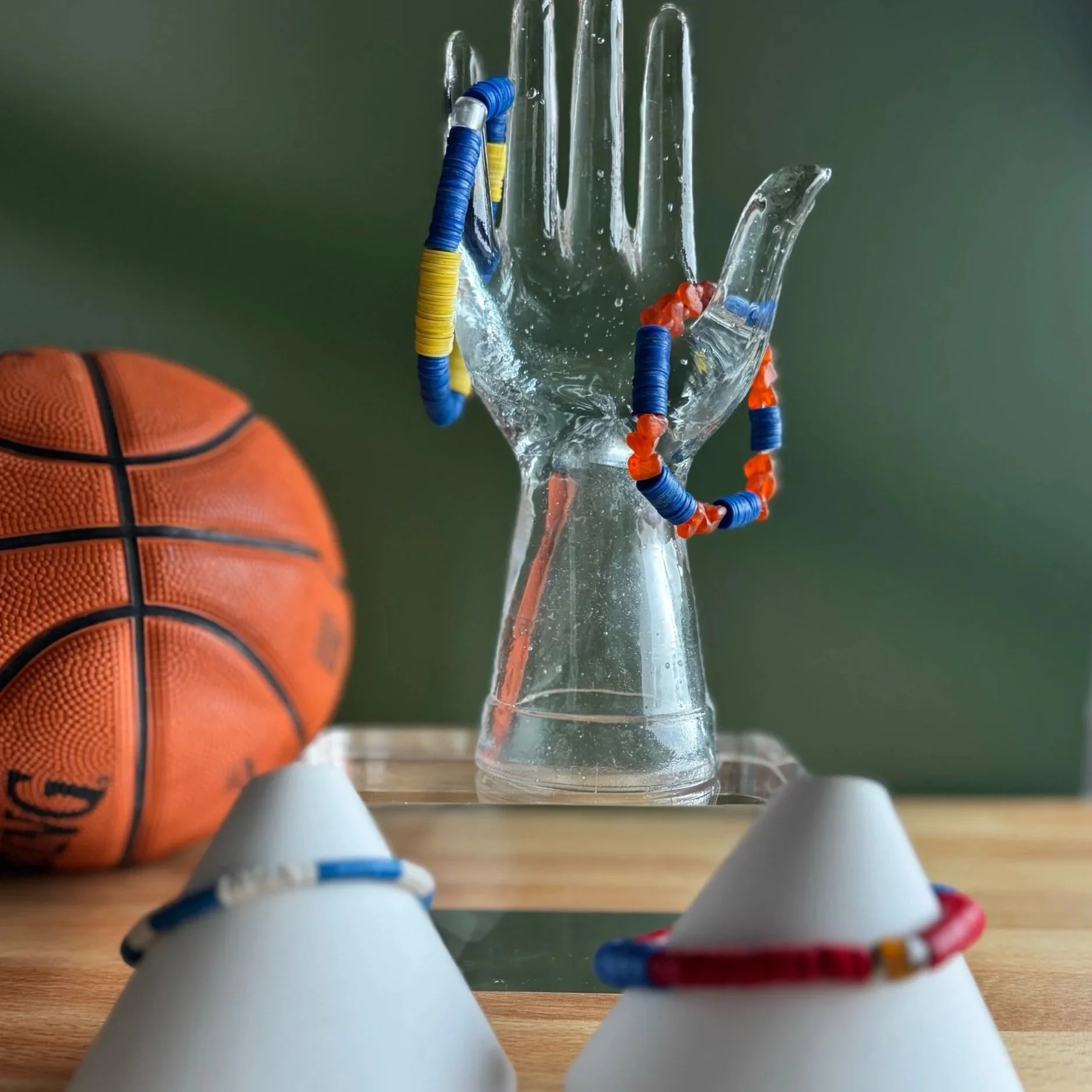 School pride-colored vinyl and glass bracelets