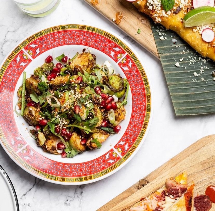 Yummy Yummy Brussel Sprouts

Deep fried brussel sprouts are tossed in a mixture of garlic black bean sauce and spicy sichuan chili oil, then topped with cilantro, pomegranate seeds, green onion and sesame. These definitely aren&rsquo;t your grandma&r