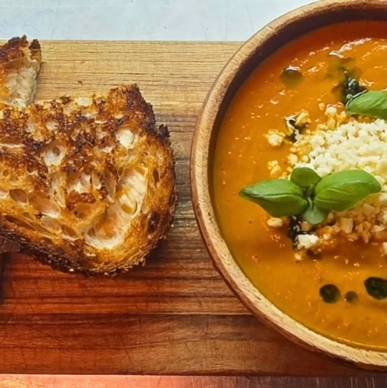 Is there anything better than a piping-hot bowl of tomato soup on a cold day?
Yes &mdash; when it comes with a golden grilled cheese on the side. 🥣🧀

Our San Marzano tomato bisque is rich and cozy, topped with cotija and basil oil. Pair it with an 