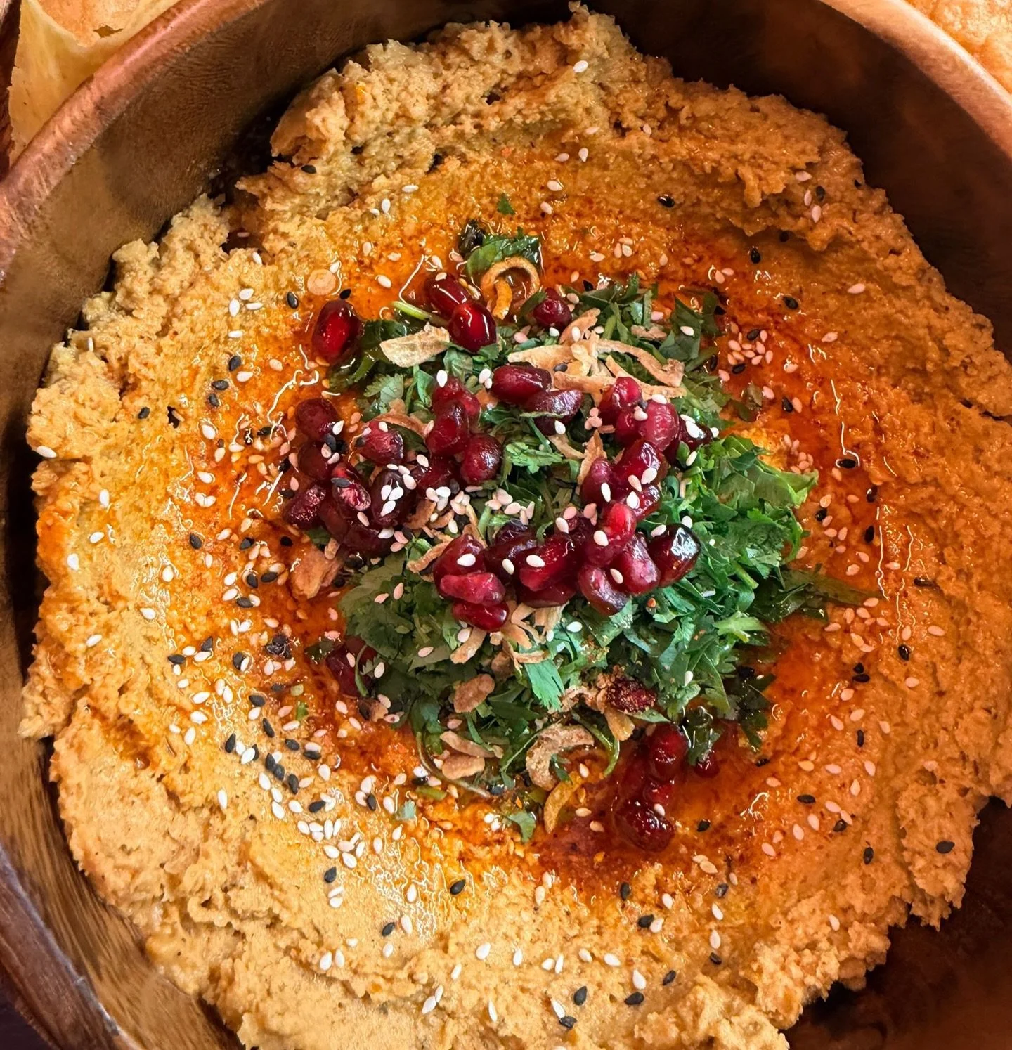 Made for passing, dipping, and lingering a little longer.

Adobo-spiced hummus with pomegranate, birria oil, herbs, and a bright taj&iacute;n finish &mdash; served with flatbread or chips.

A perfect winter warm-up to share. 🧡
#chadwicksTO
