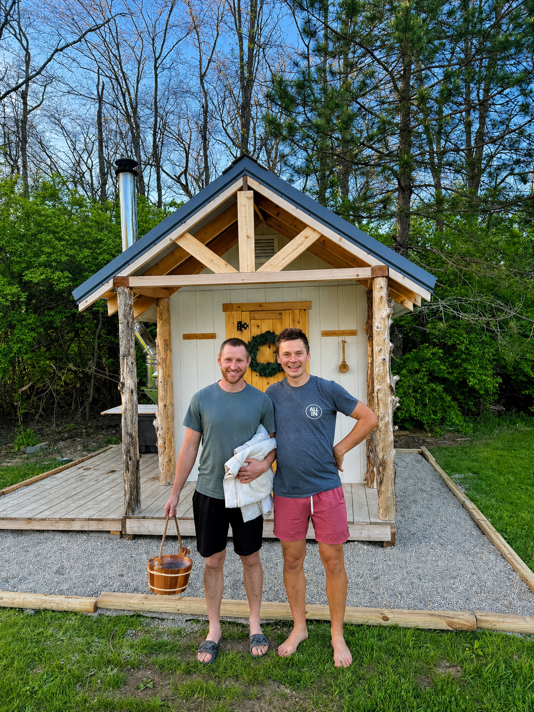 vilppu and ryan in front of wood-burning cabin style sauna with cedar posts