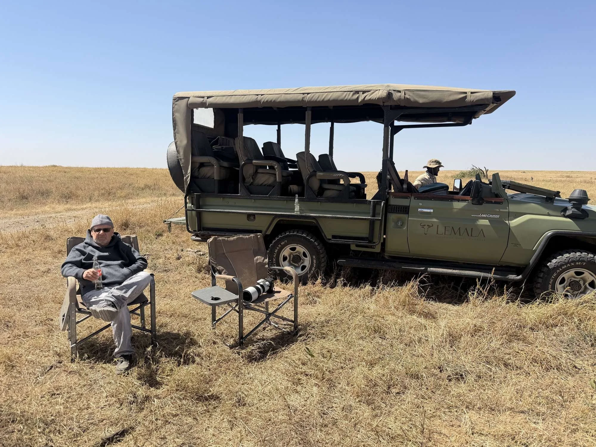 Lemala Nanyukie's open-sided Land Cruiser on the plains, with camp chairs set out for a coffee stop
