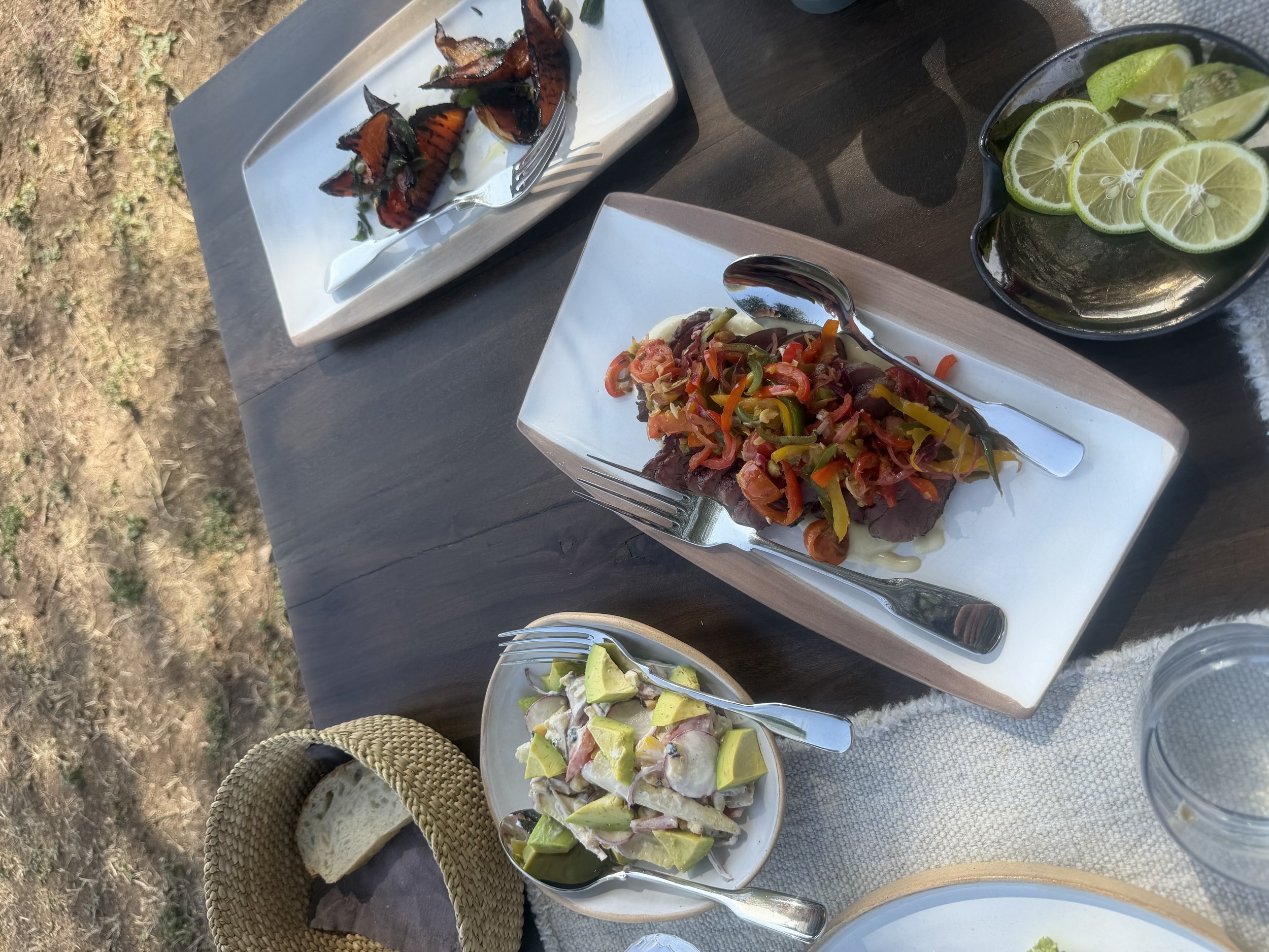 Salads and grilled vegetables for lunch at Mila, served outdoors with sliced lime