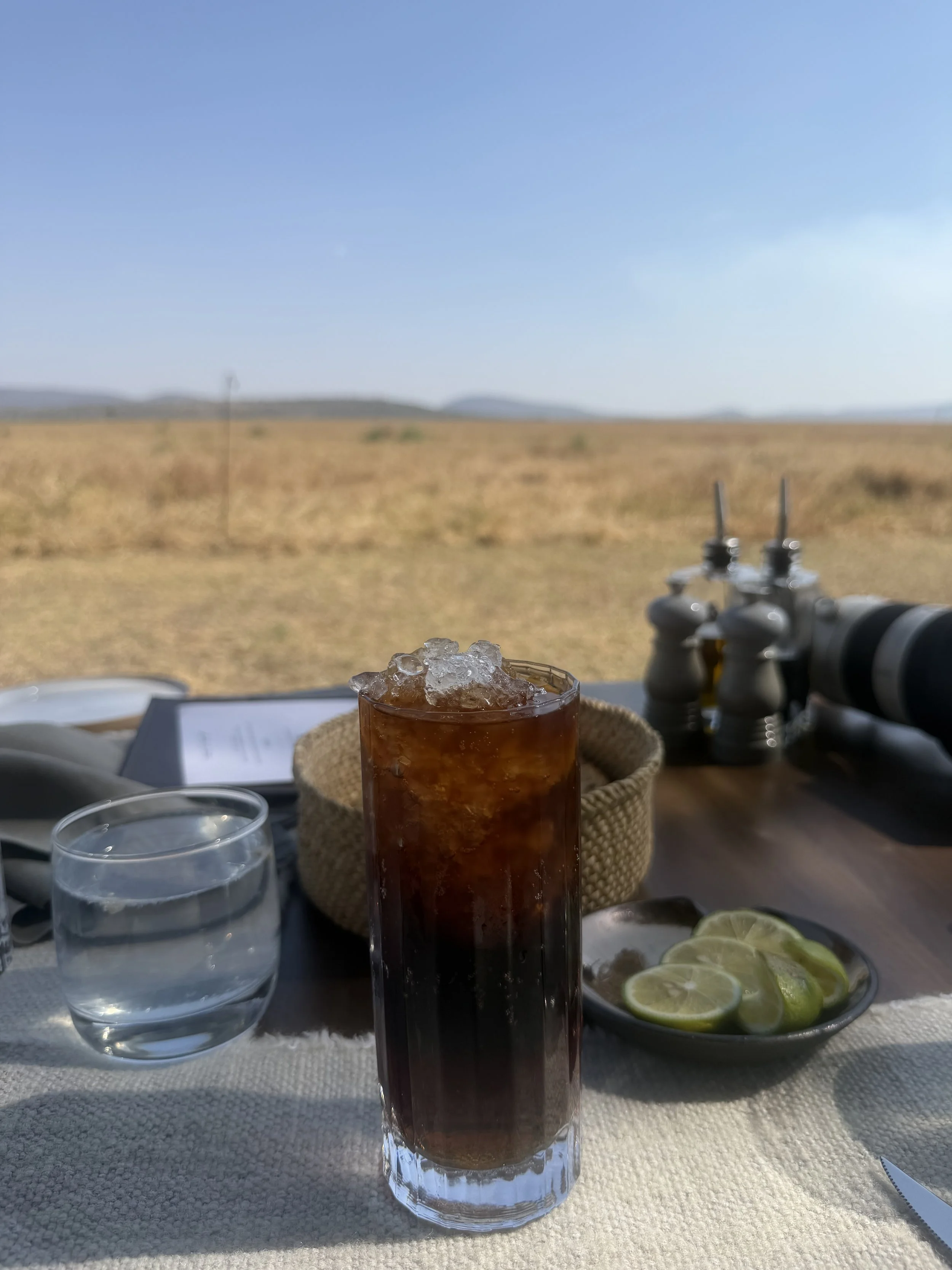 A soda over crushed ice at lunch, on a table looking out over the dry Serengeti plains