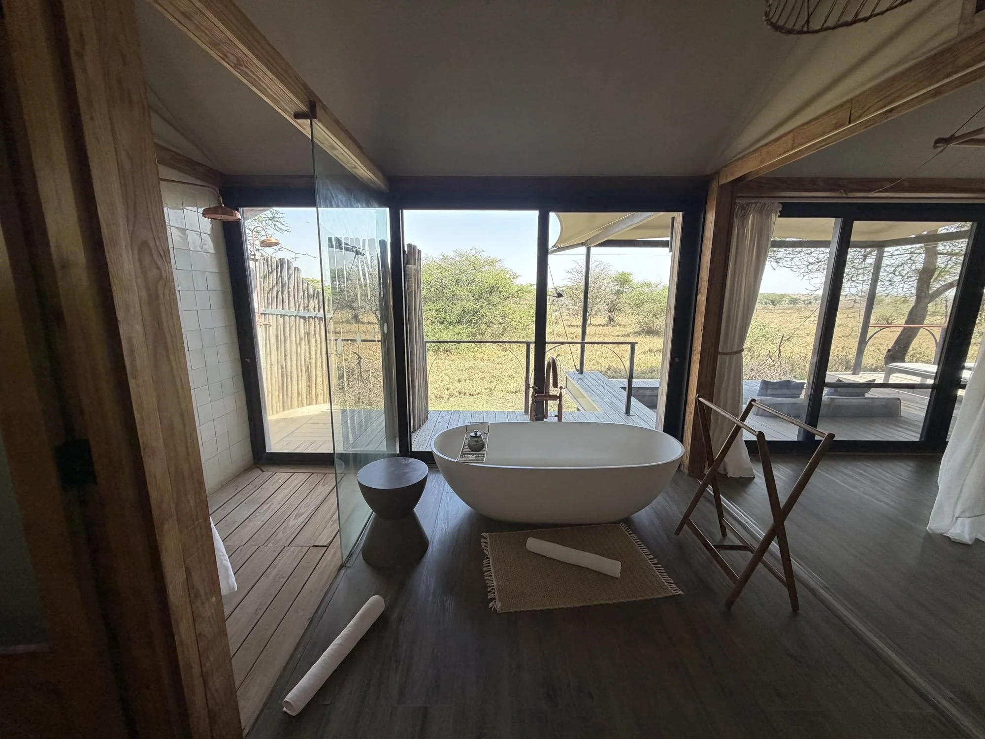 Bathroom with a freestanding tub and glass shower in a Lemala Nanyukie suite