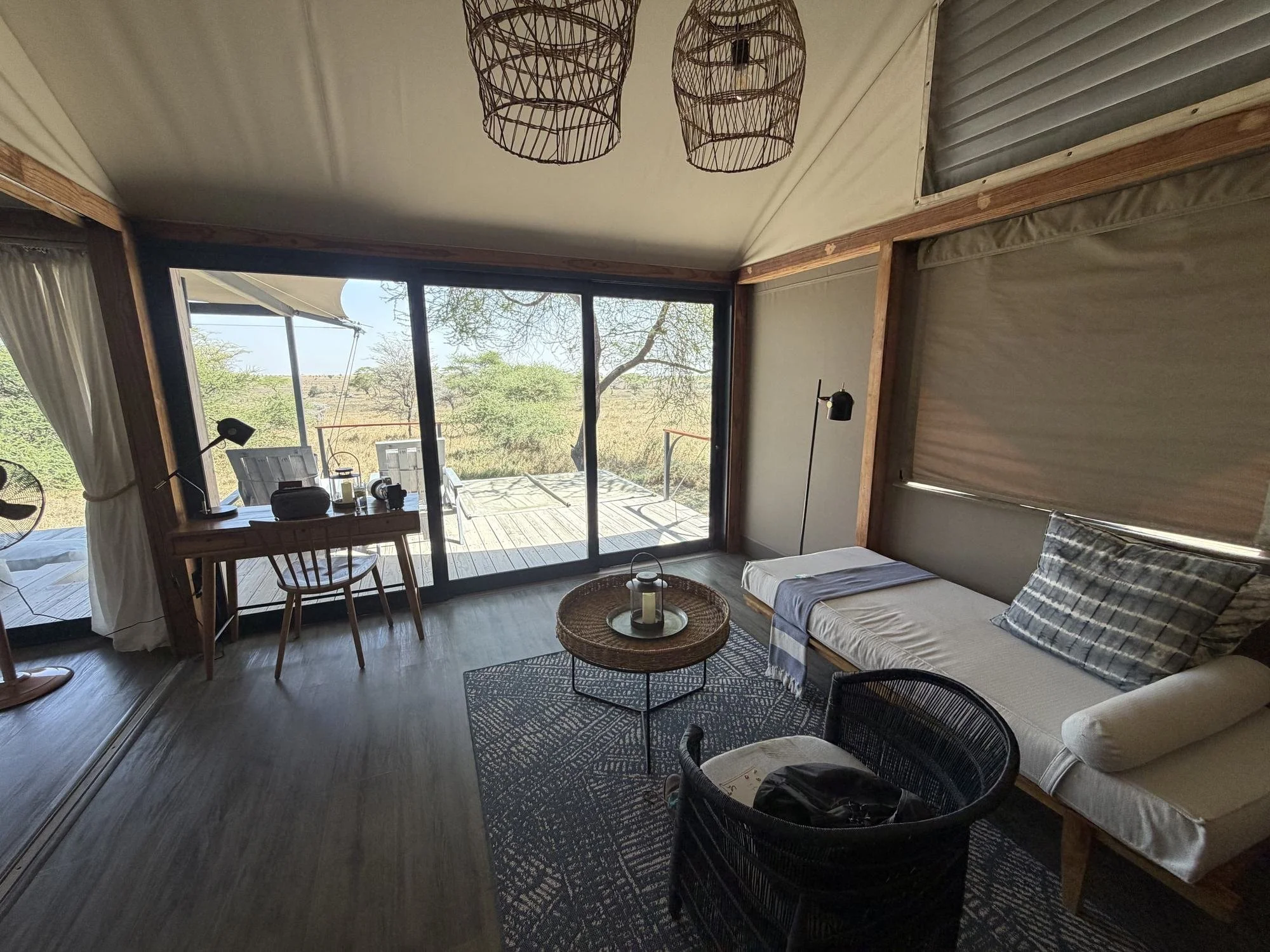 Seating area with a day bed and a desk at the window in a Lemala Nanyukie suite